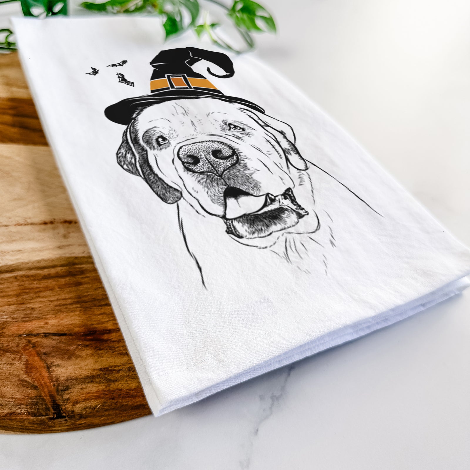 Hand-drawn sketch of Wendy the Saint Bernard wearing a witch hat on a tea towel