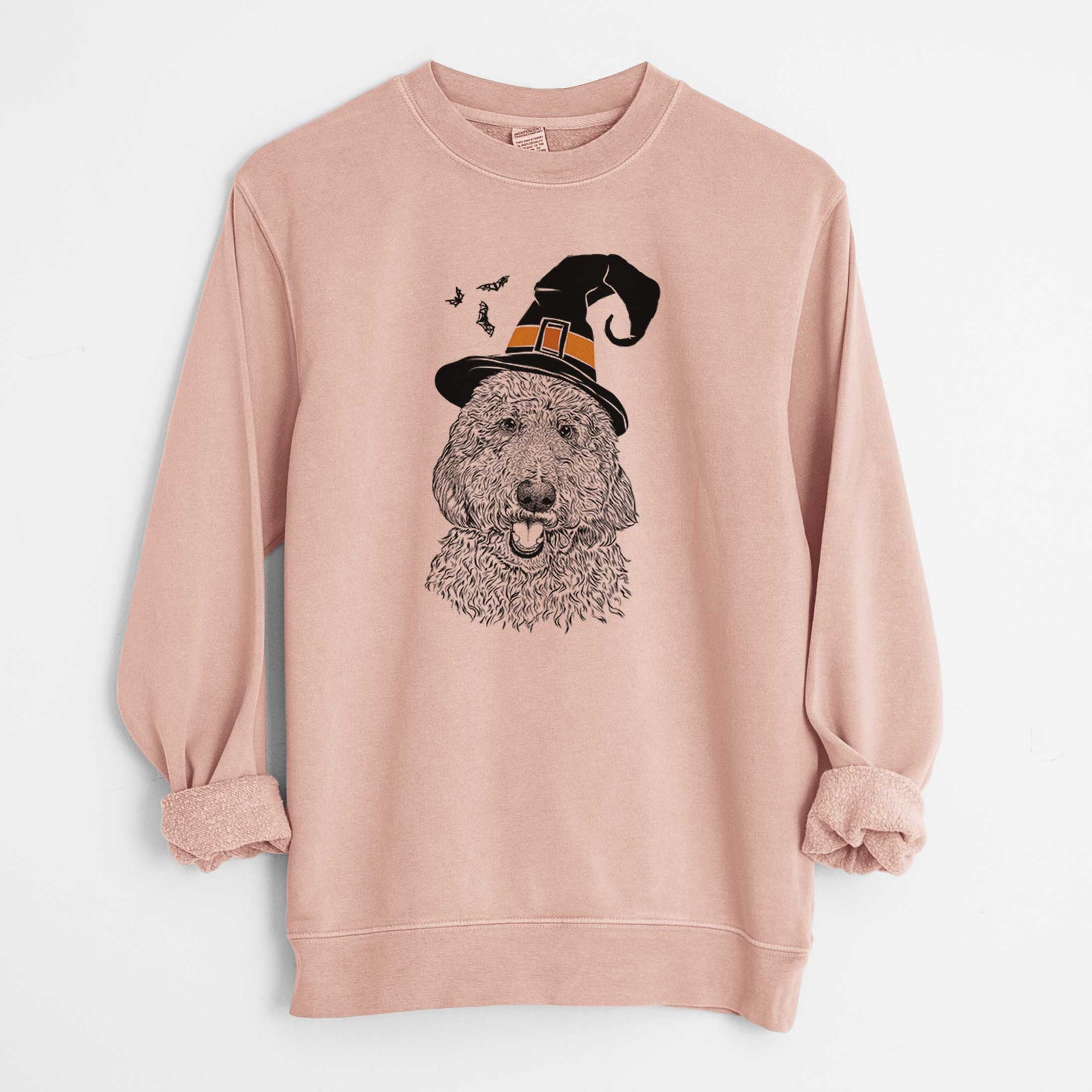 Hand-drawn sketch of Whisper the Goldendoodle wearing a witch hat on a Dusty Pink Unisex pigment dyed crew sweatshirt