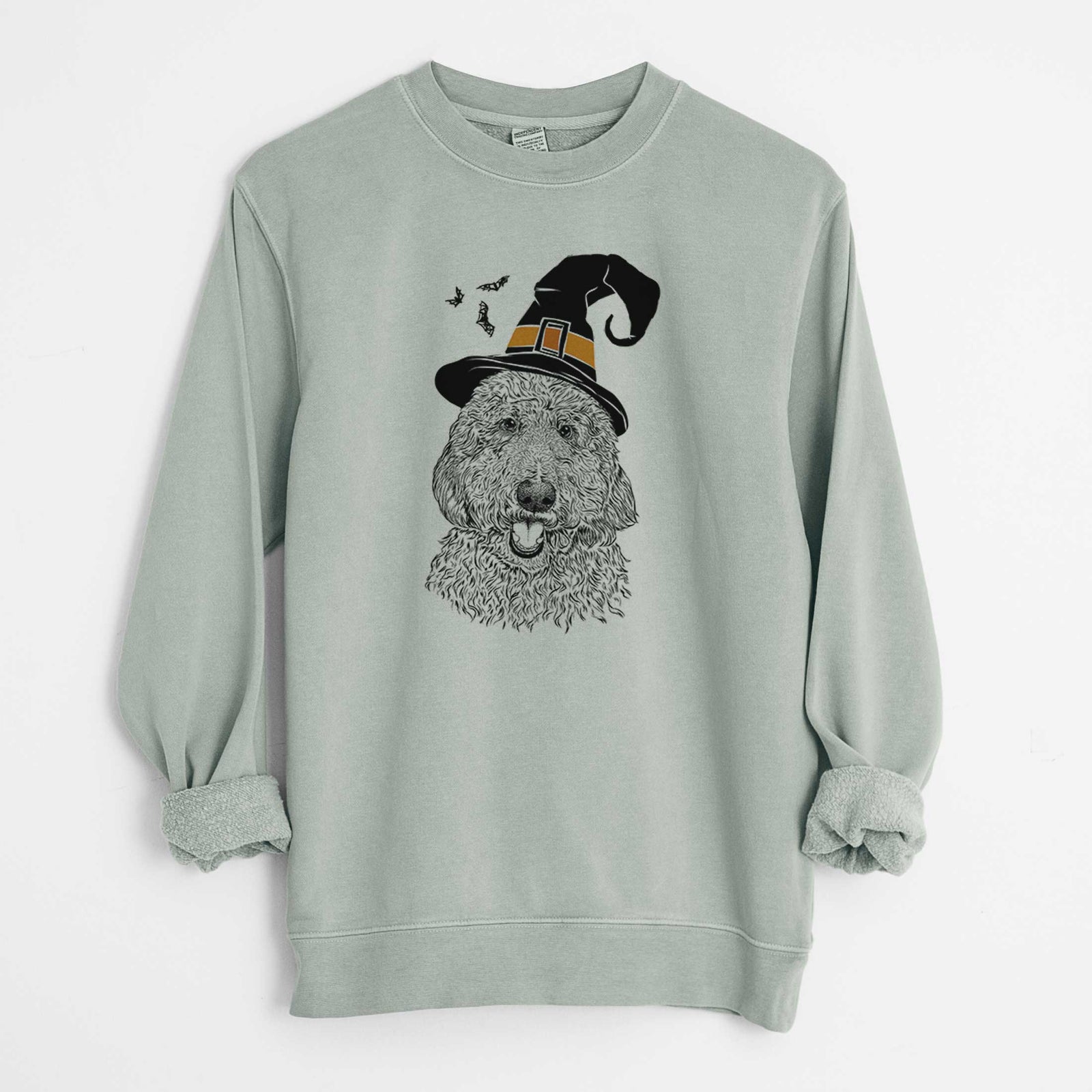 Hand-drawn sketch of Whisper the Goldendoodle wearing a witch hat on a Sage Unisex pigment dyed crew sweatshirt
