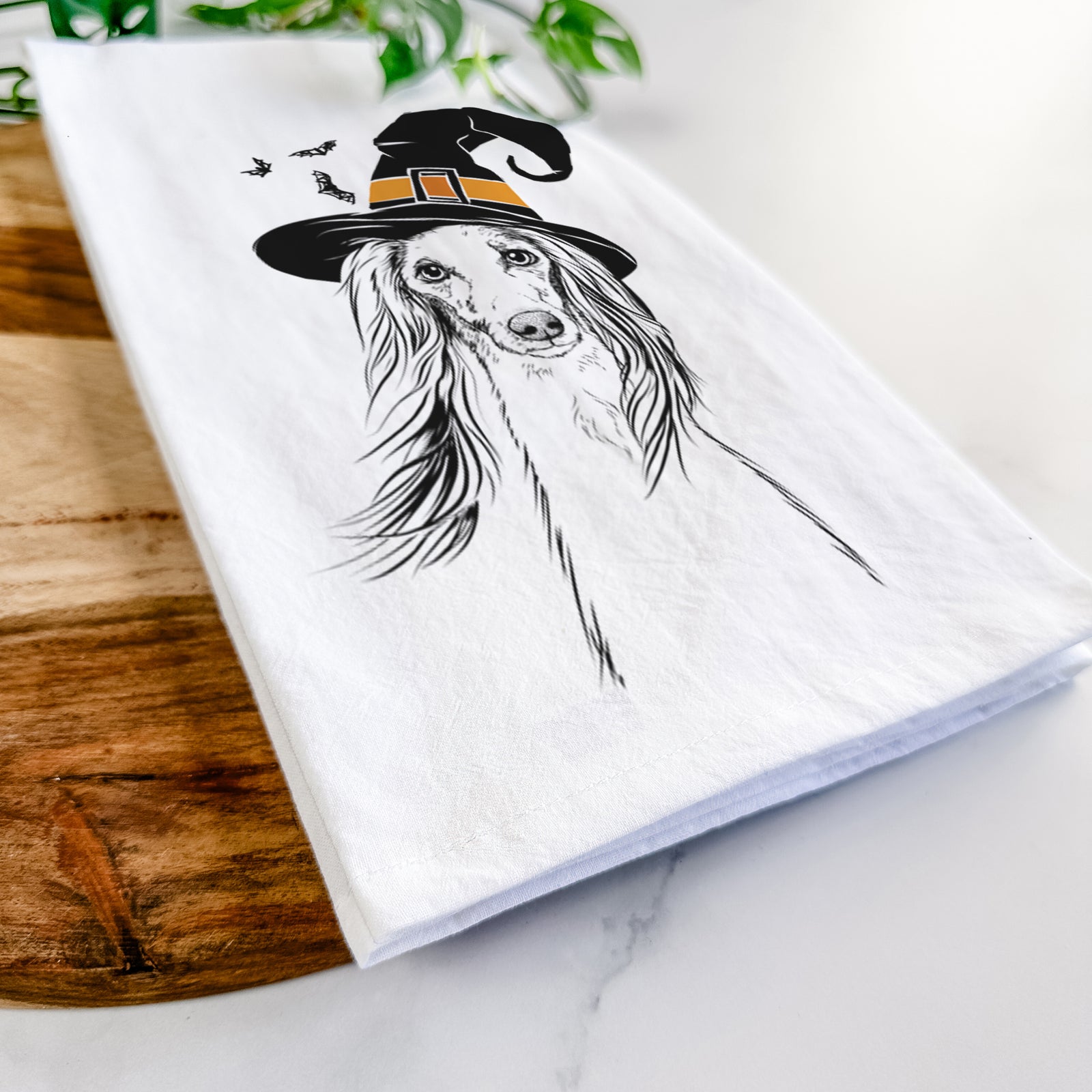 Hand-drawn sketch of Zahra the Saluki wearing a witch hat on a tea towel