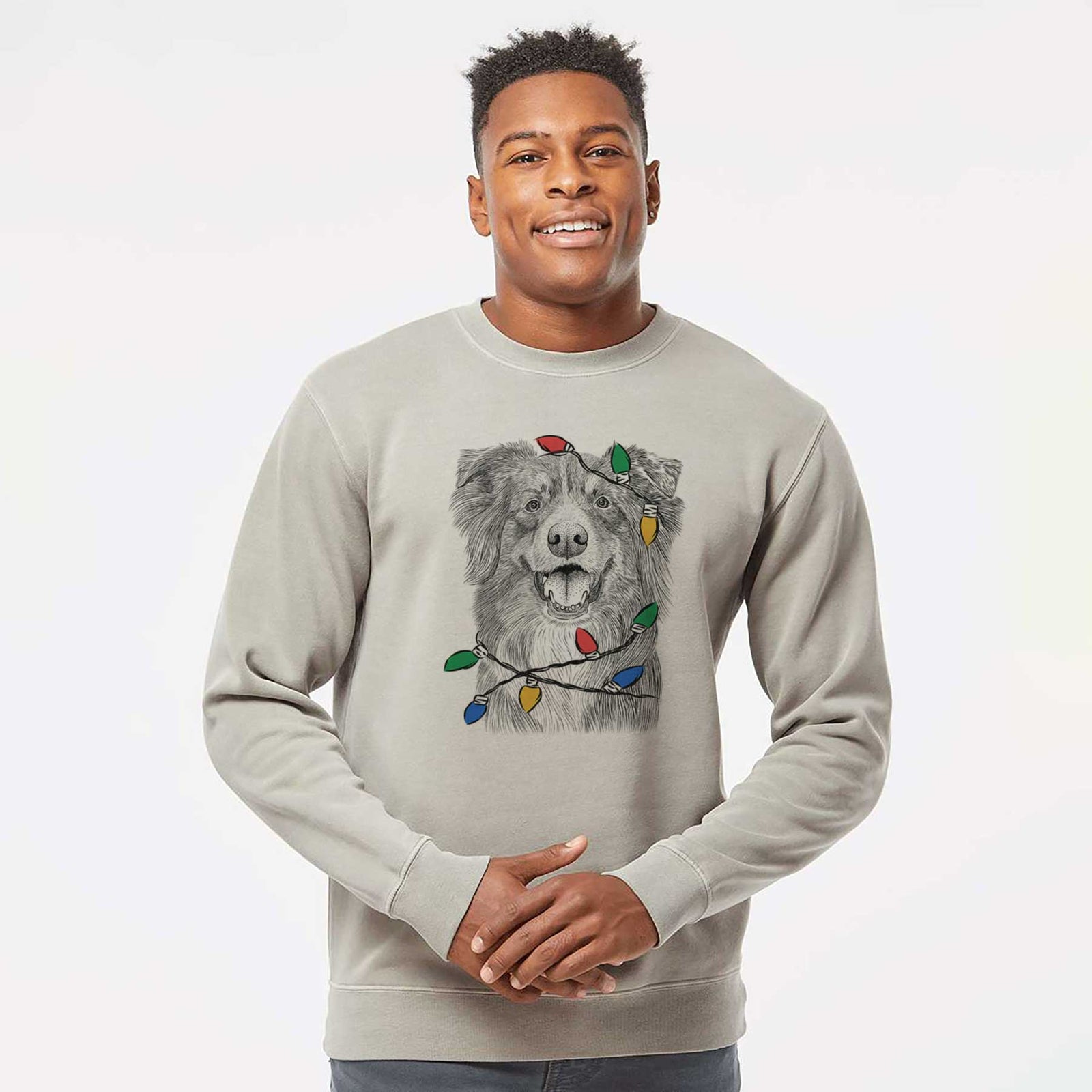 Hand-drawn sketch of Aussie Parker the Australian Shepherd wrapped in Christmas lights on a Cement Unisex pigment dyed crew sweatshirt