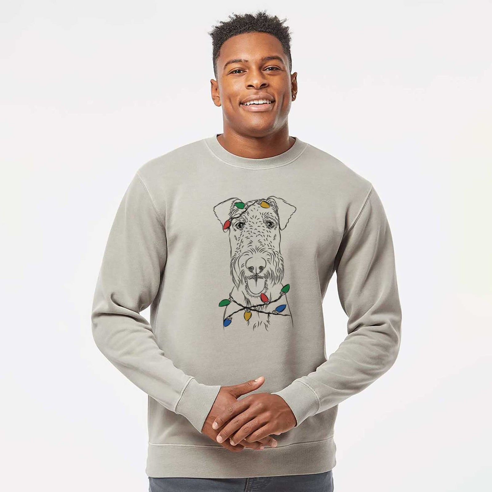 Hand-drawn sketch of Andy the Airedale Terrier wrapped in Christmas lights on a Cement Unisex pigment dyed crew sweatshirt