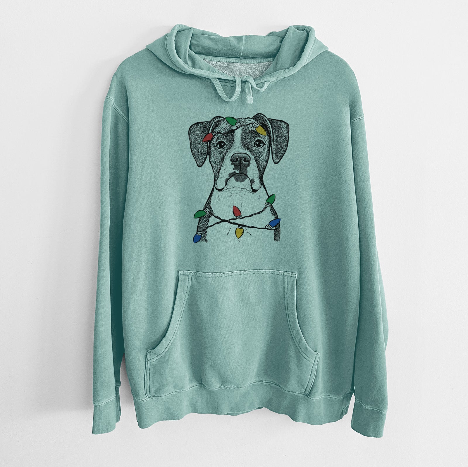Hand-drawn sketch of Annie the Boxer wrapped in Christmas lights on a Mint Unisex pigment dyed hoodie