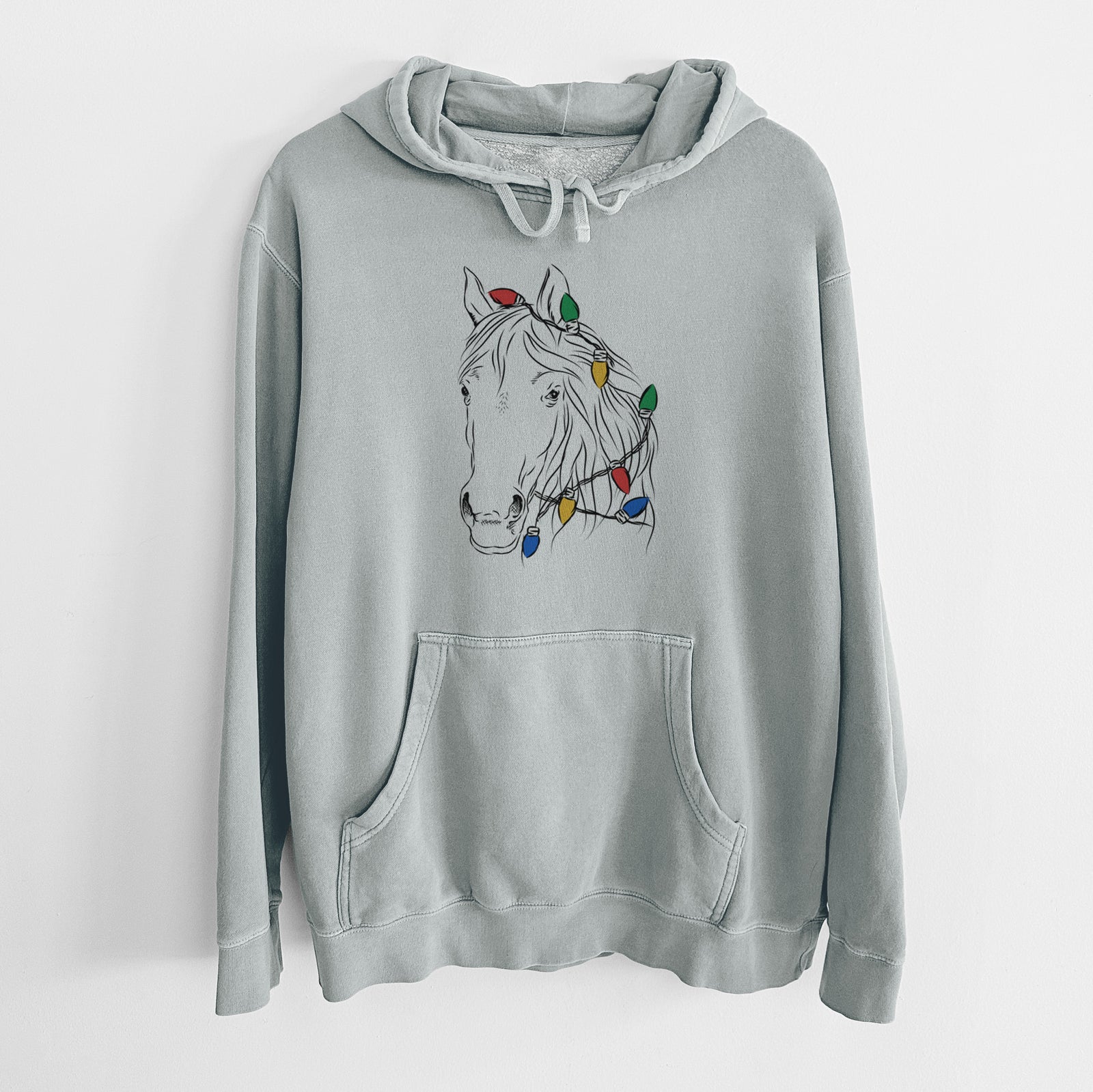 Hand-drawn sketch of Aria the Horse wrapped in Christmas lights on a Sage Unisex pigment dyed hoodie