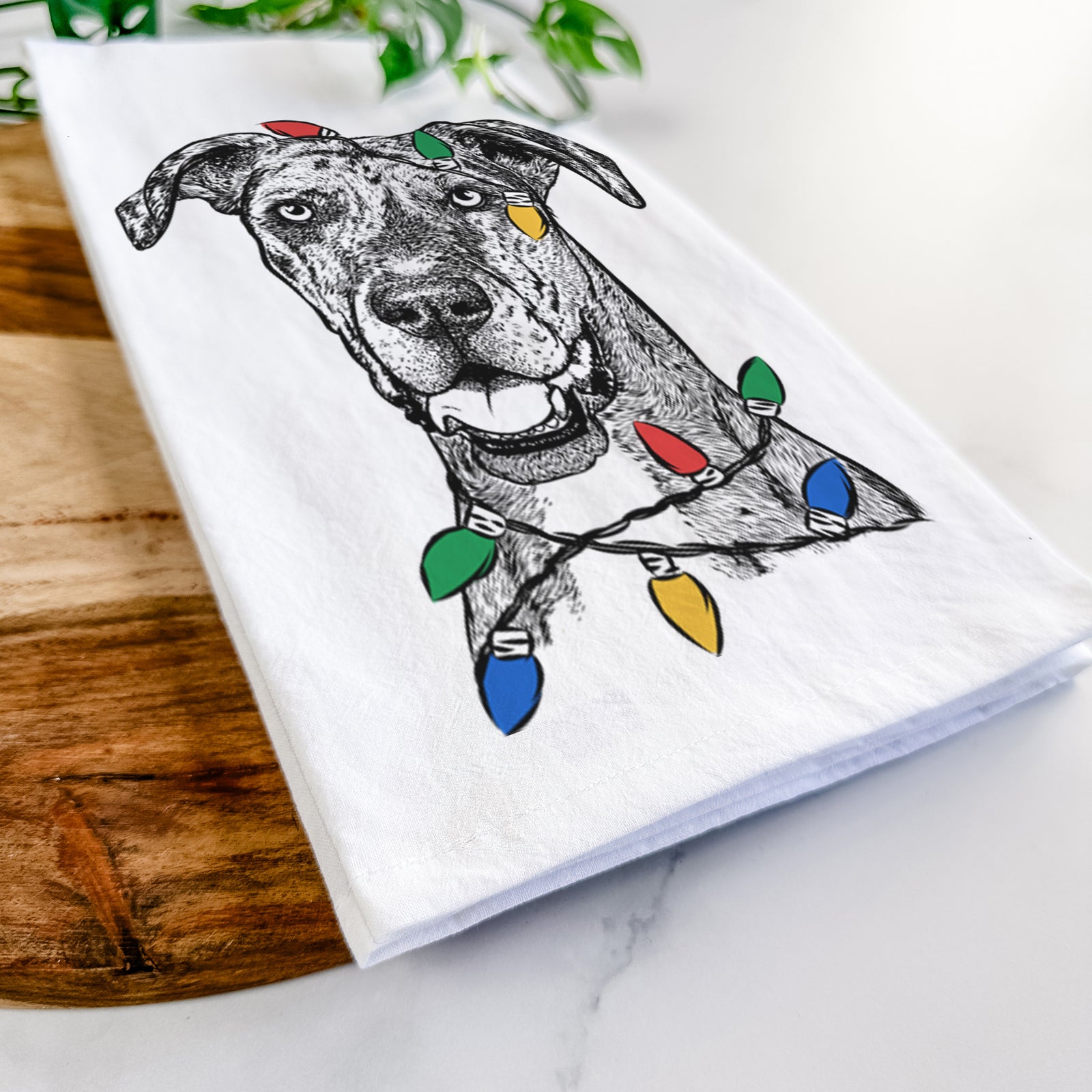 Hand-drawn sketch of Athena the Merle Great Dane wrapped in Christmas lights on a tea towel