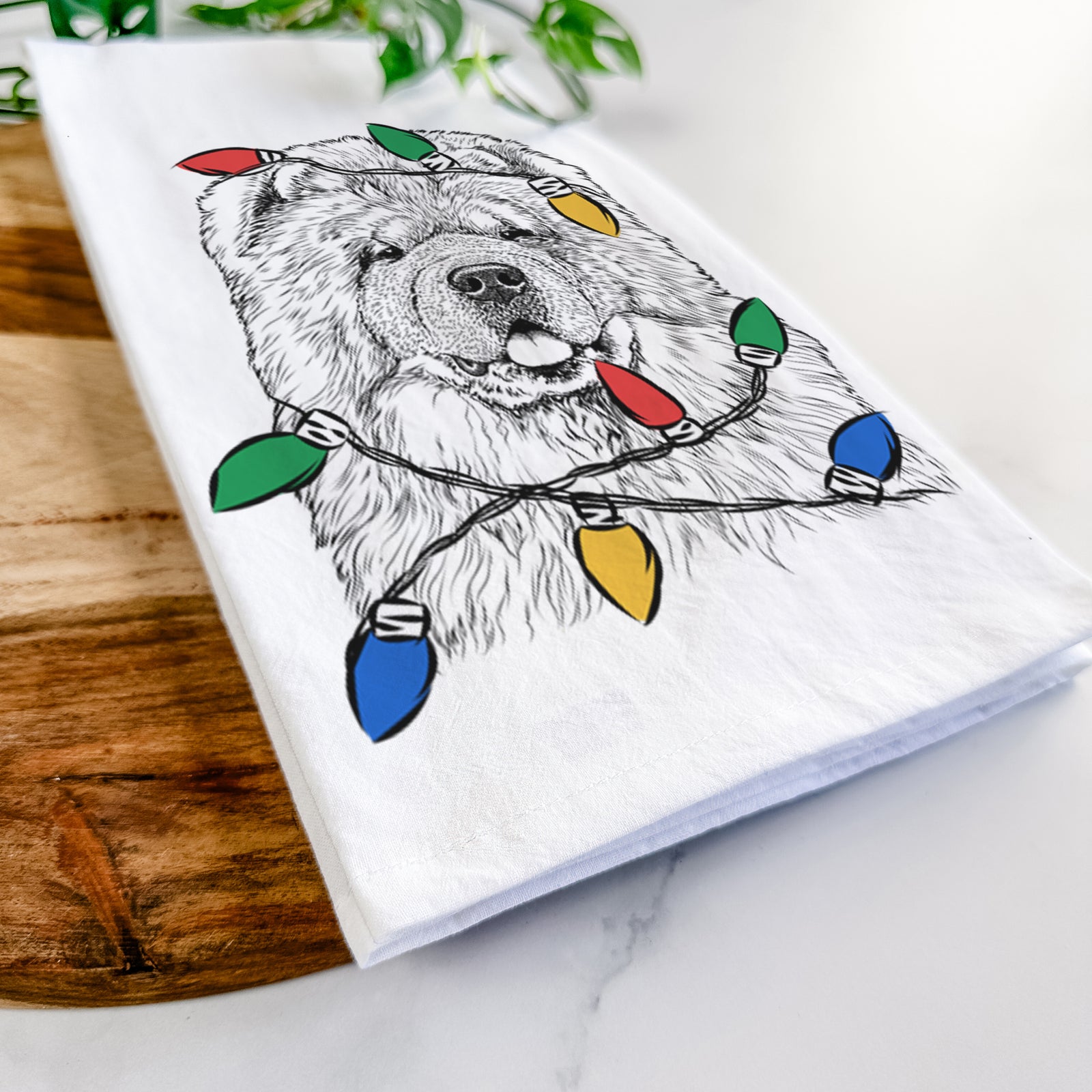 Hand-drawn sketch of Baloo the Chow Chow wrapped in Christmas lights on a tea towel