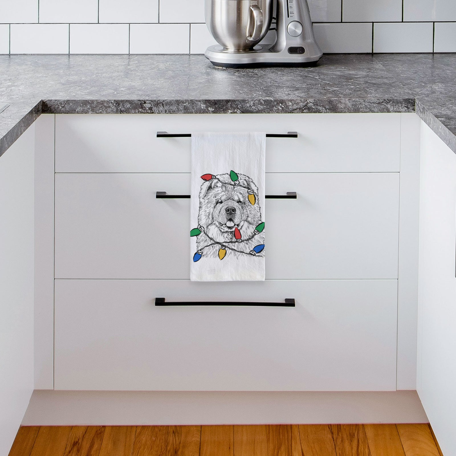 Hand-drawn sketch of Baloo the Chow Chow wrapped in Christmas lights on a tea towel, hanging on an oven door in a kitchen