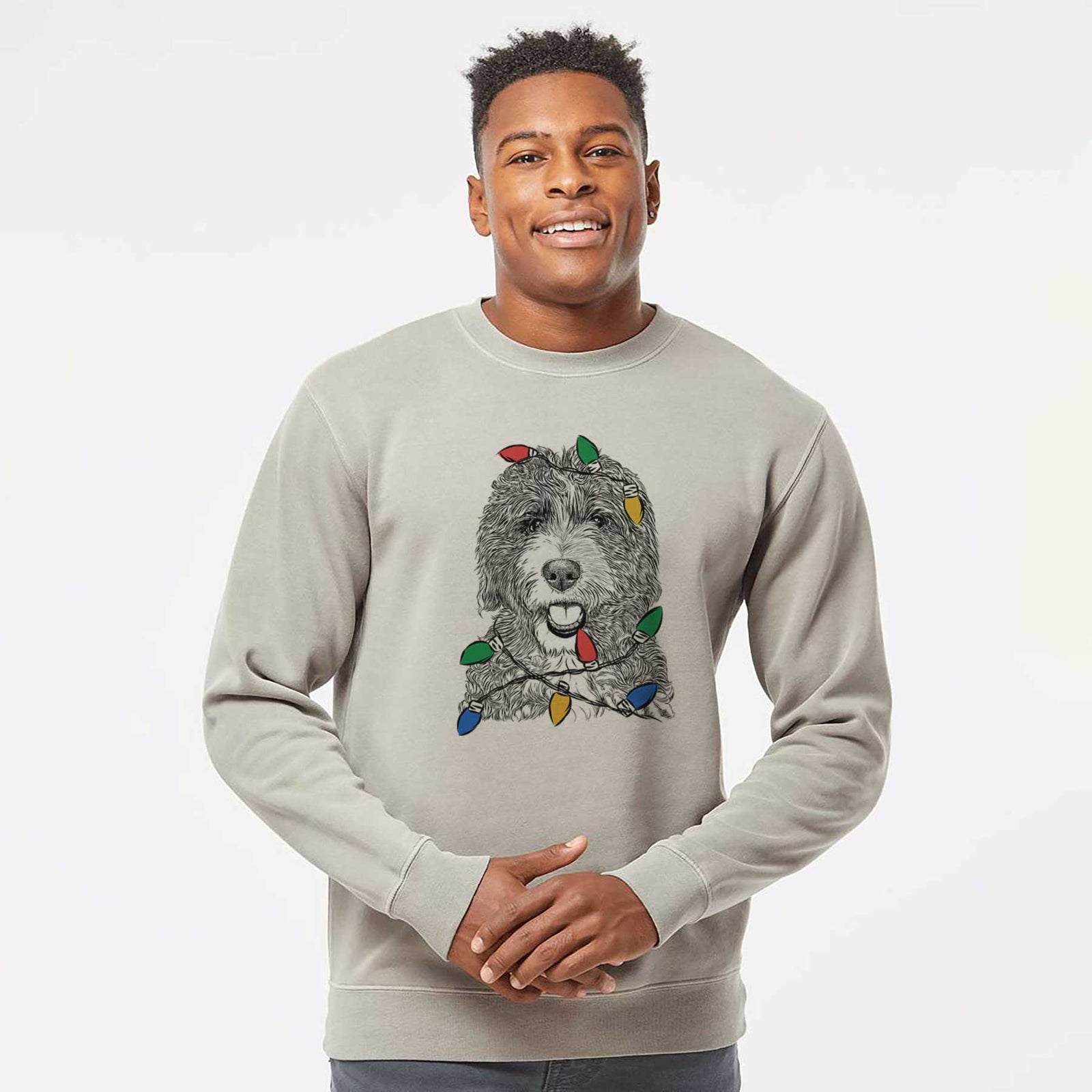 Hand-drawn sketch of Bash the Bernedoodle wrapped in Christmas lights on a Cement Unisex pigment dyed crew sweatshirt