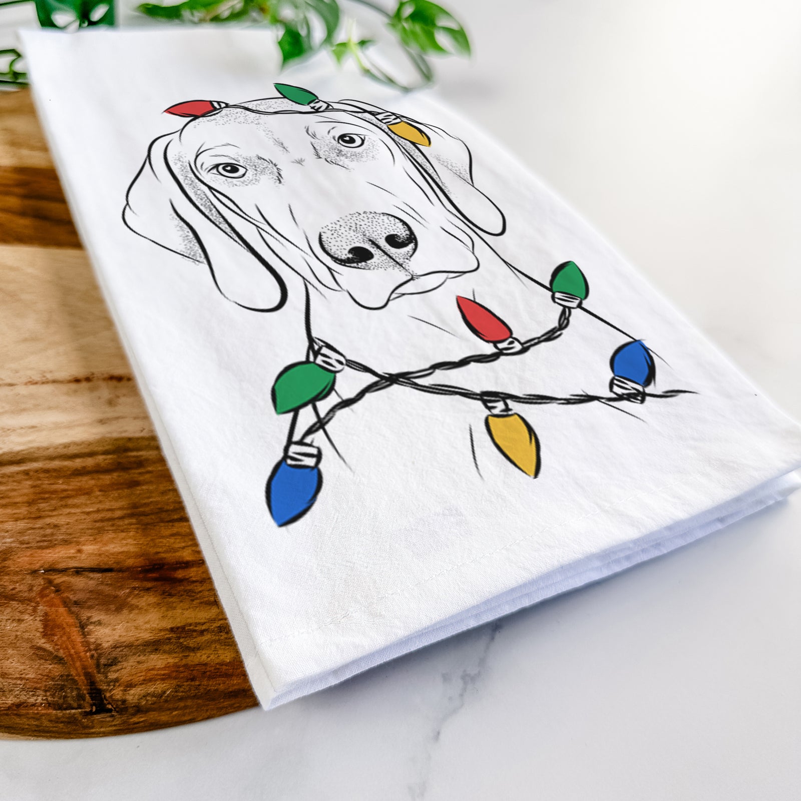 Hand-drawn sketch of Benelli the Vizsla wrapped in Christmas lights on a tea towel