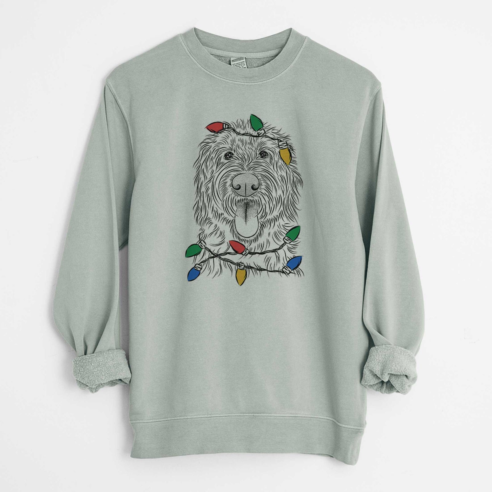 Hand-drawn sketch of Bennett the Doodle wrapped in Christmas lights on a Sage Unisex pigment dyed crew sweatshirt