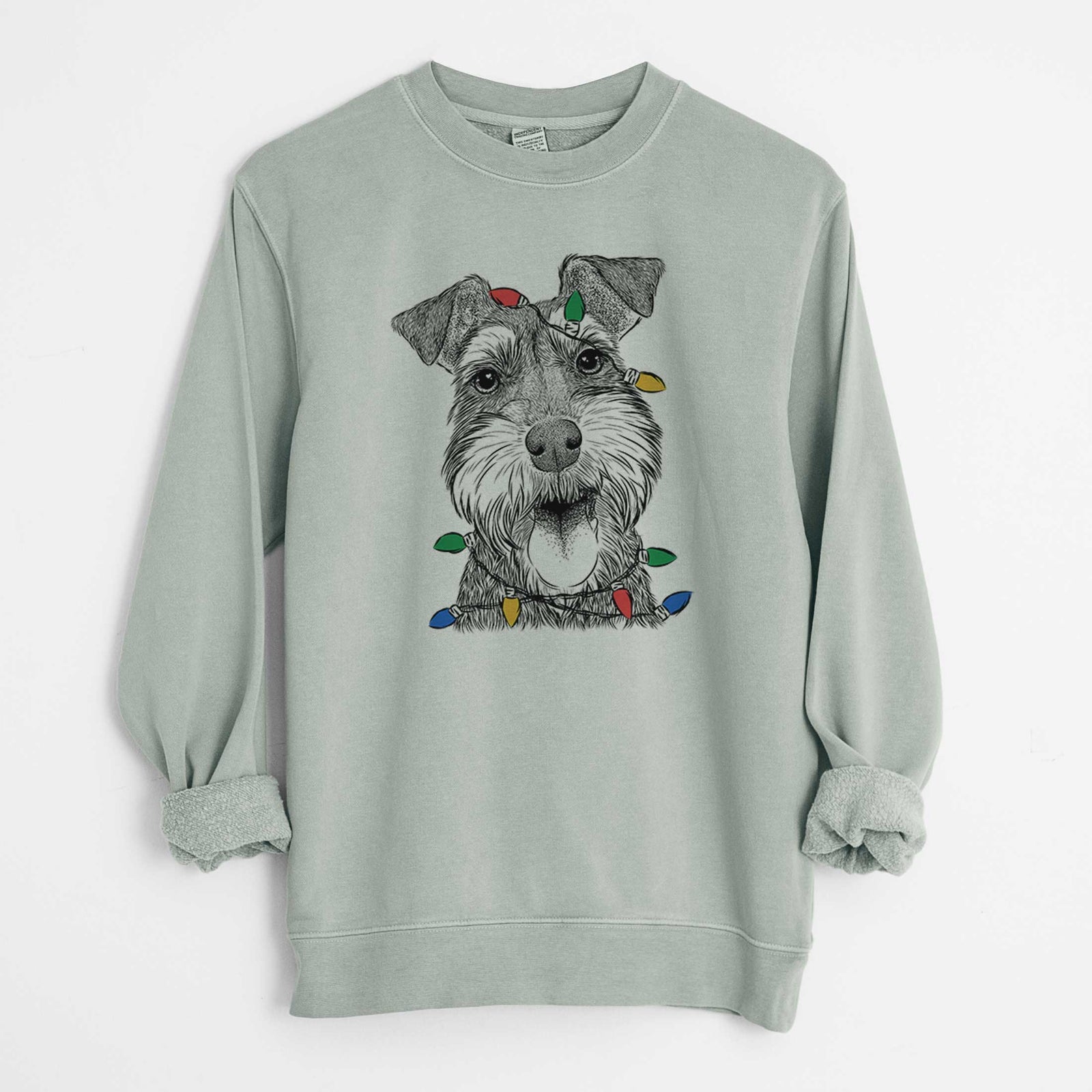 Hand-drawn sketch of Bernadette the Mini Schnauzer wrapped in Christmas lights on a Sage Unisex pigment dyed crew sweatshirt