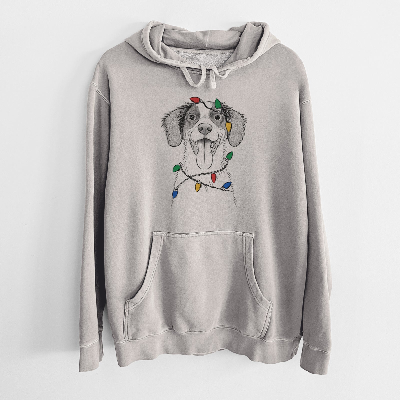 Hand-drawn sketch of Birdie the Brittany wrapped in Christmas lights on a Cement Unisex pigment dyed hoodie