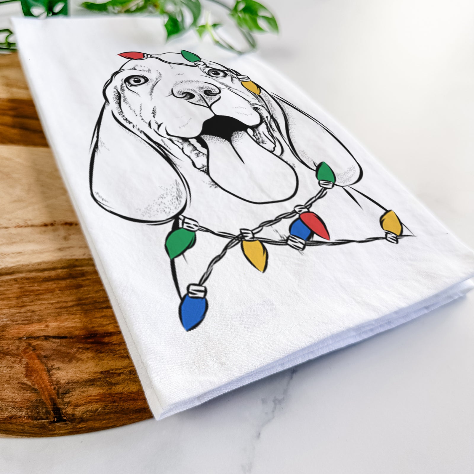 Hand-drawn sketch of Bodi the Vizsla wrapped in Christmas lights on a tea towel