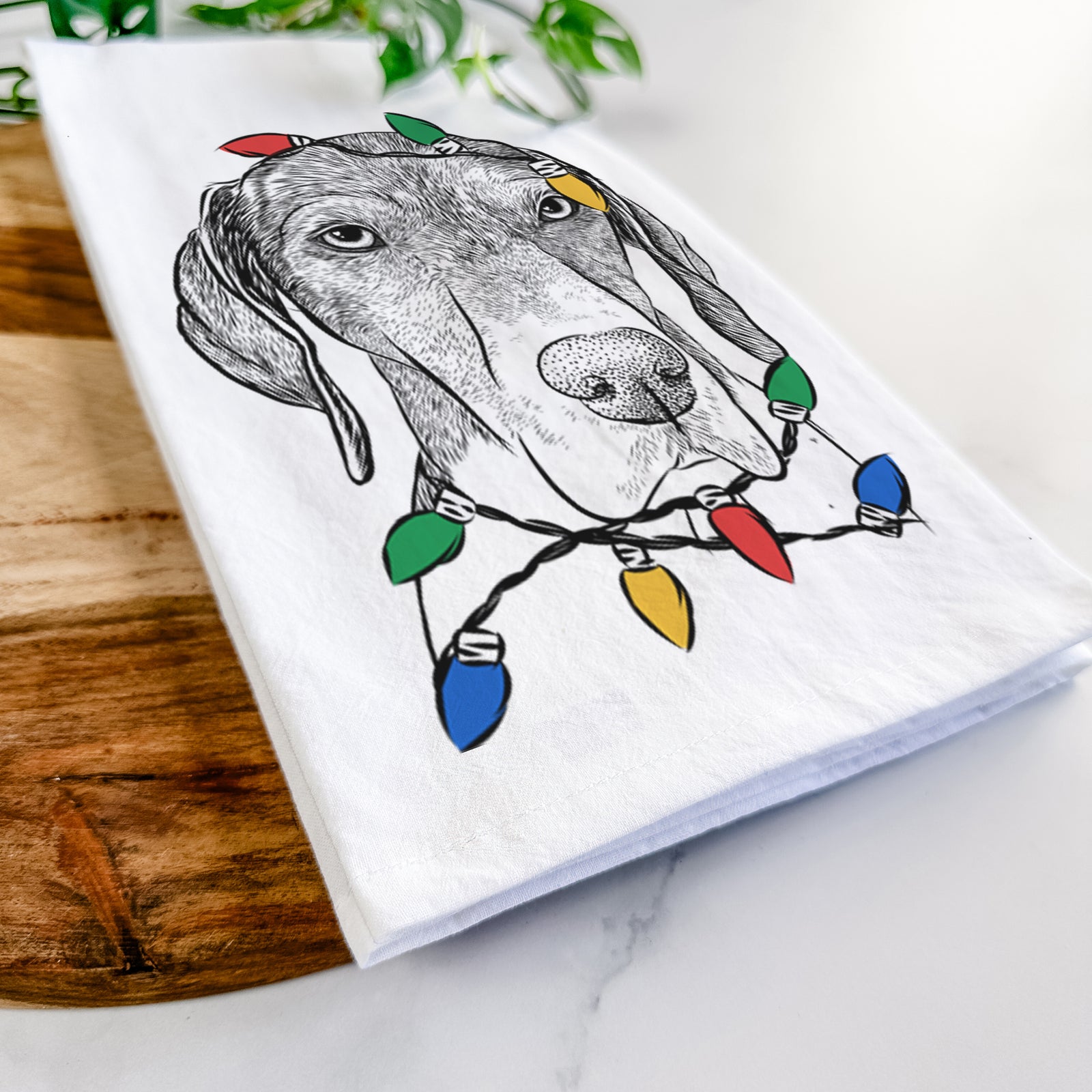 Hand-drawn sketch of Bohdi the German Shorthaired Pointer wrapped in Christmas lights on a tea towel