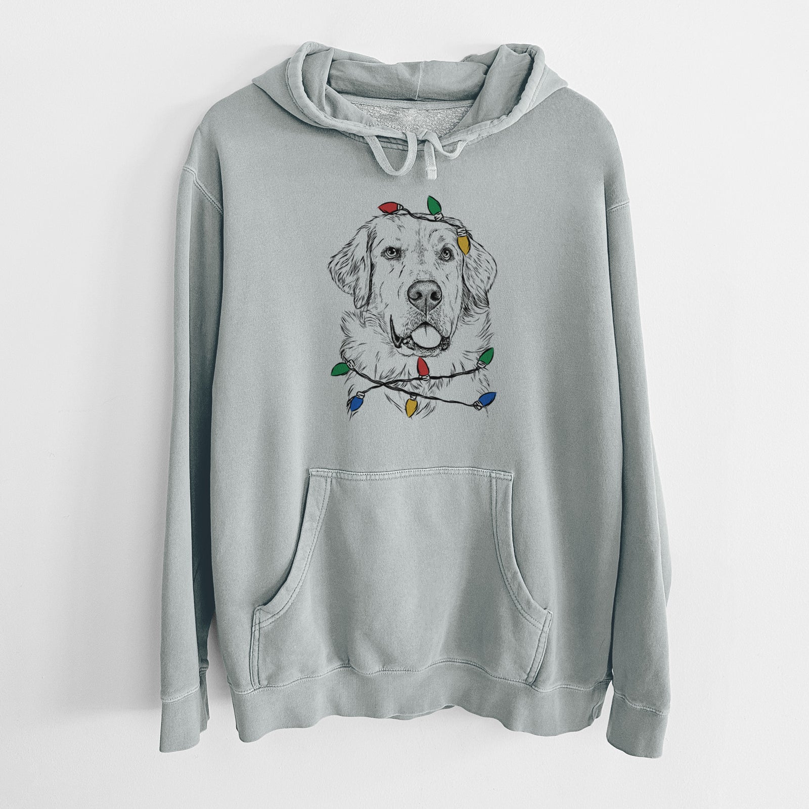 Hand-drawn sketch of Brophy the Great Pyrenees wrapped in Christmas lights on a Sage Unisex pigment dyed hoodie