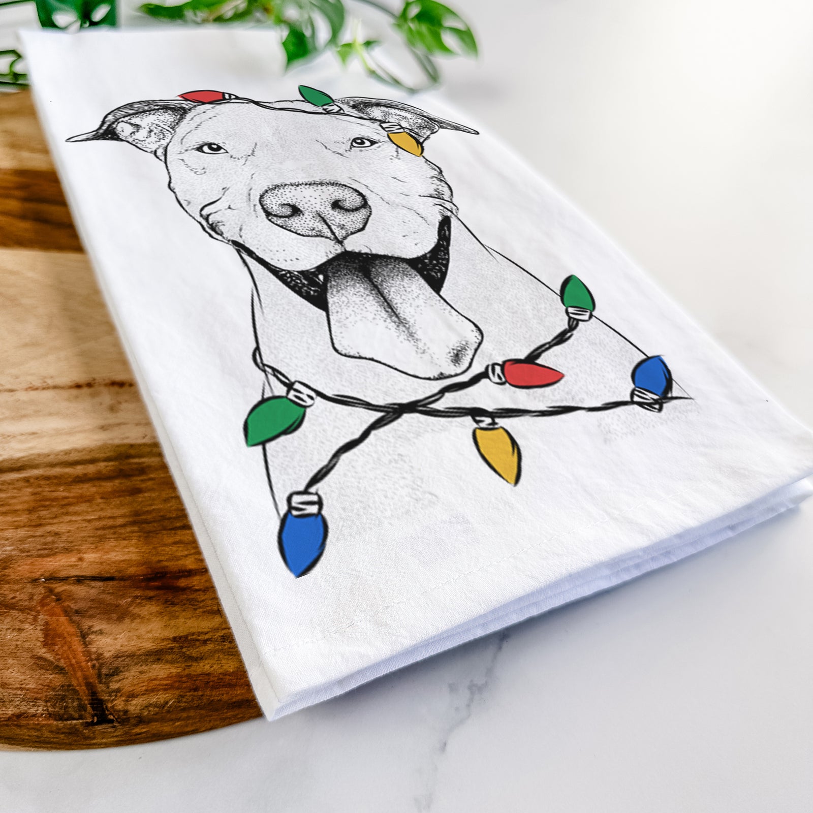 Hand-drawn sketch of Bruce the American Staffordshire Terrier wrapped in Christmas lights on a tea towel