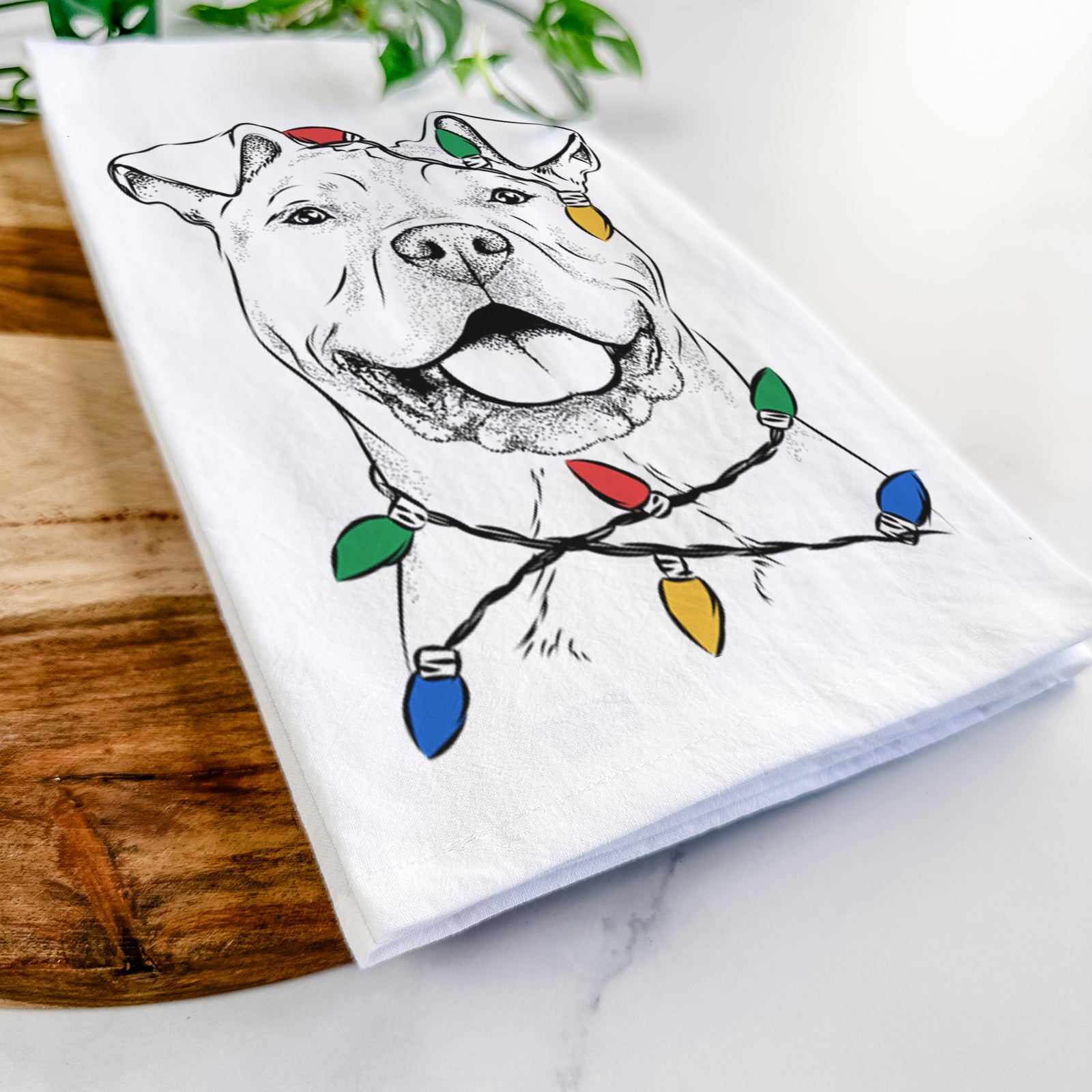 Hand-drawn sketch of Bubba Scraps the American Staffordshire Mix wrapped in Christmas lights on a tea towel