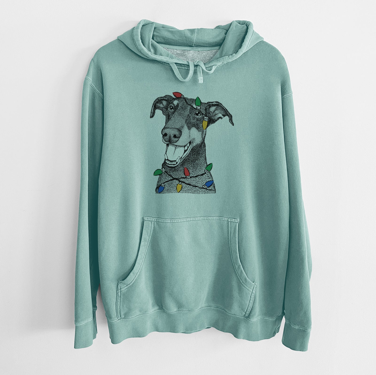 Hand-drawn sketch of Bunnie the Doberman Pinscher wrapped in Christmas lights on a Mint Unisex pigment dyed hoodie