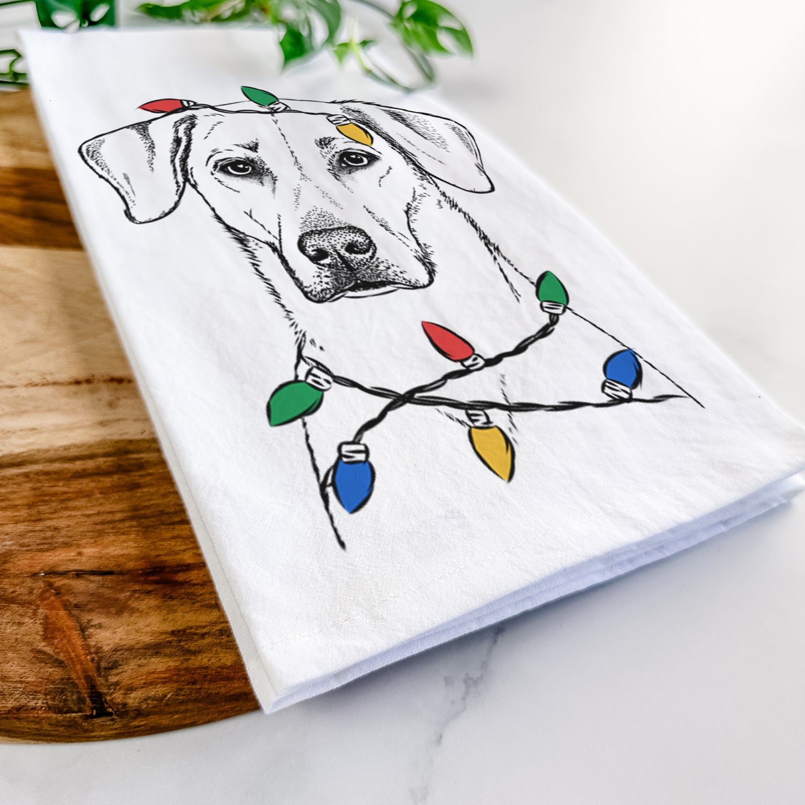 Hand-drawn sketch of Charlie Girl the Yellow Lab wrapped in Christmas lights on a tea towel