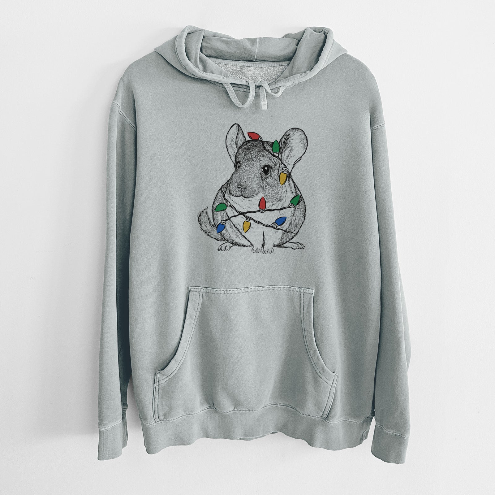 Hand-drawn sketch of Cheddar the Chinchilla wrapped in Christmas lights on a Sage Unisex pigment dyed hoodie