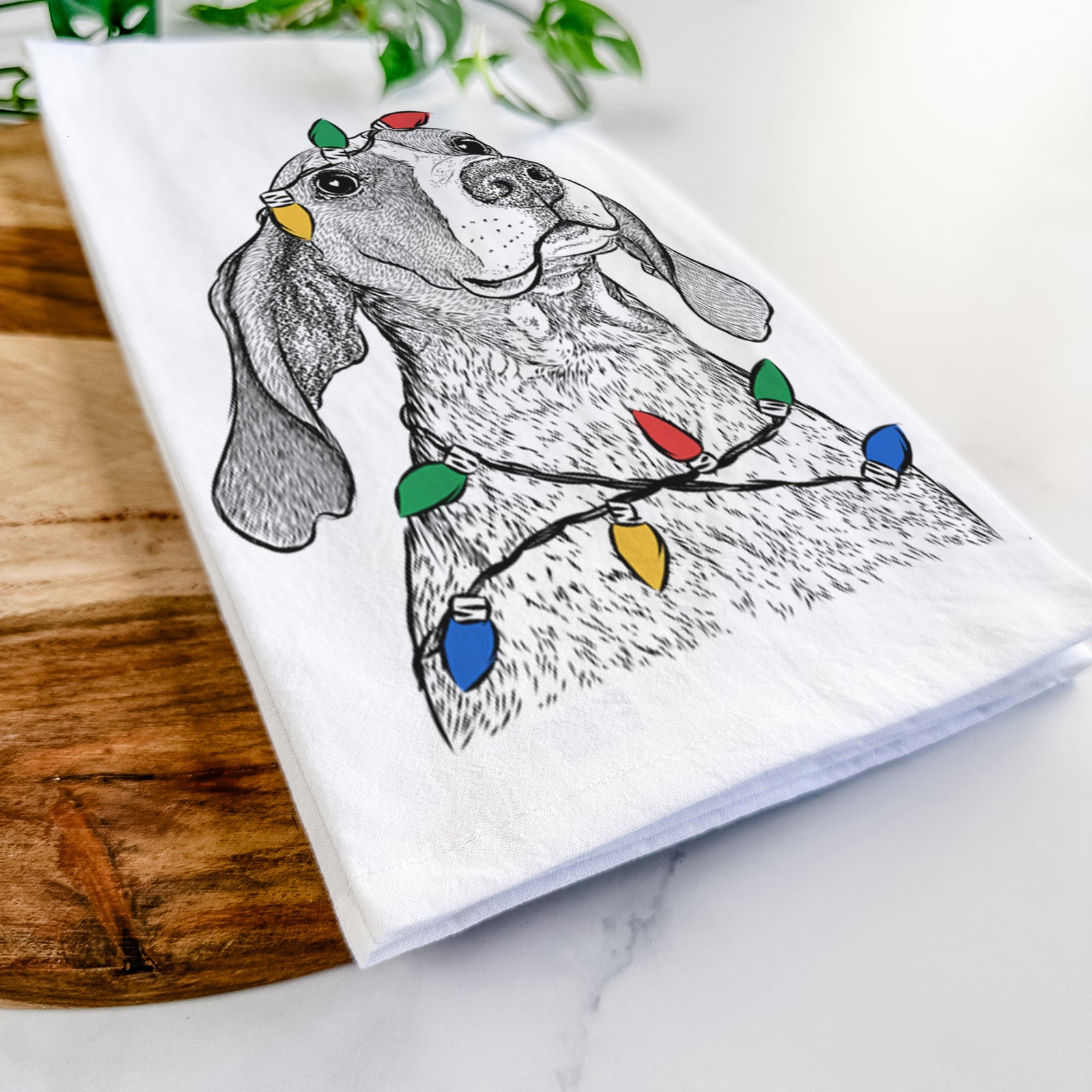 Hand-drawn sketch of Chester the Red Tick Coonhound wrapped in Christmas lights on a tea towel