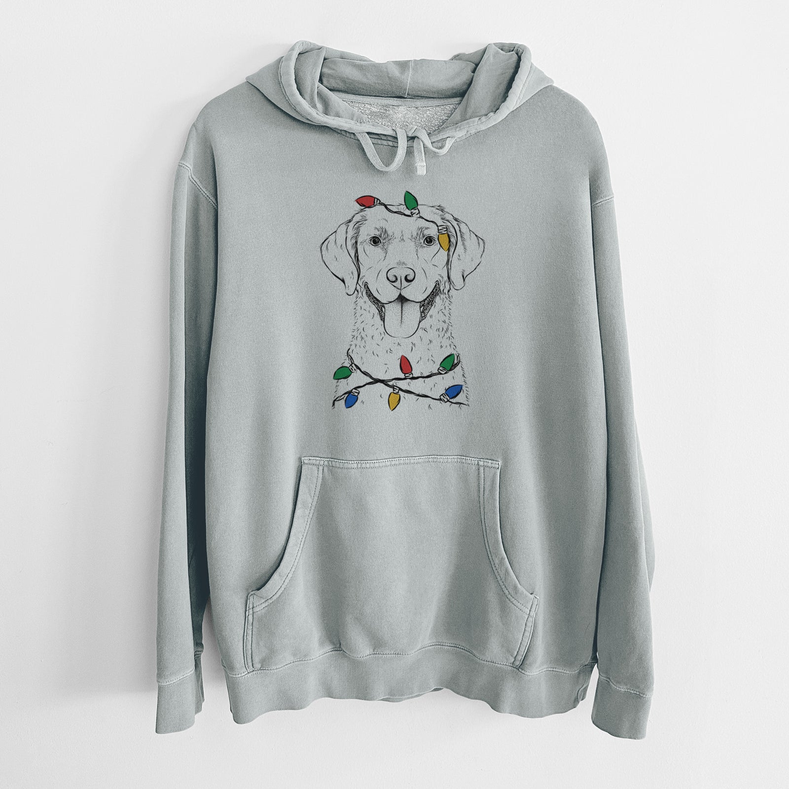Hand-drawn sketch of Chip the Chesapeake Bay Retriever wrapped in Christmas lights on a Sage Unisex pigment dyed hoodie