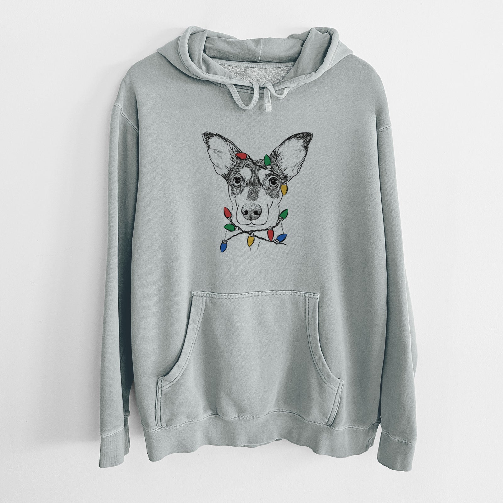 Hand-drawn sketch of Chloe the Doxie Mix wrapped in Christmas lights on a Sage Unisex pigment dyed hoodie