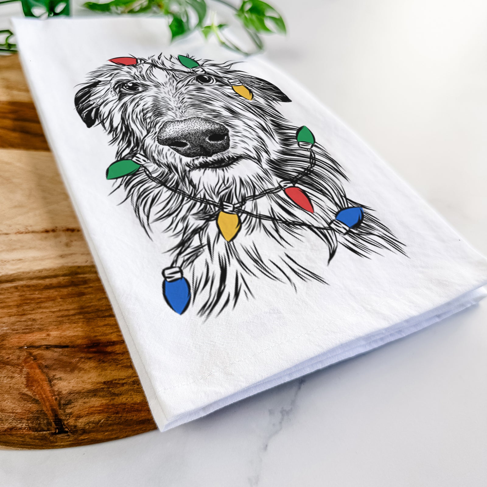Hand-drawn sketch of Cleod the Scottish Deerhound wrapped in Christmas lights on a tea towel