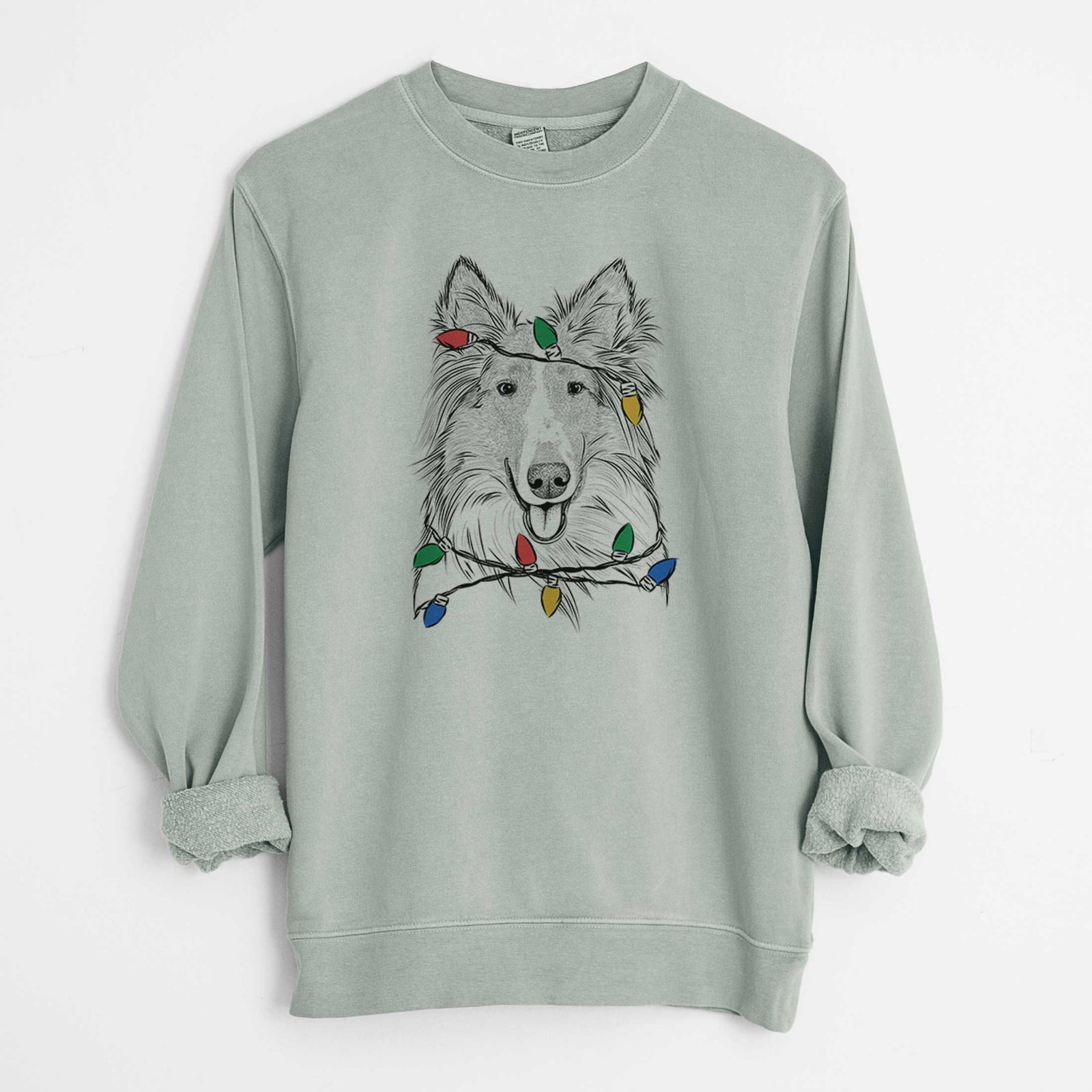 Hand-drawn sketch of Conrad the Rough Collie wrapped in Christmas lights on a Sage Unisex pigment dyed crew sweatshirt