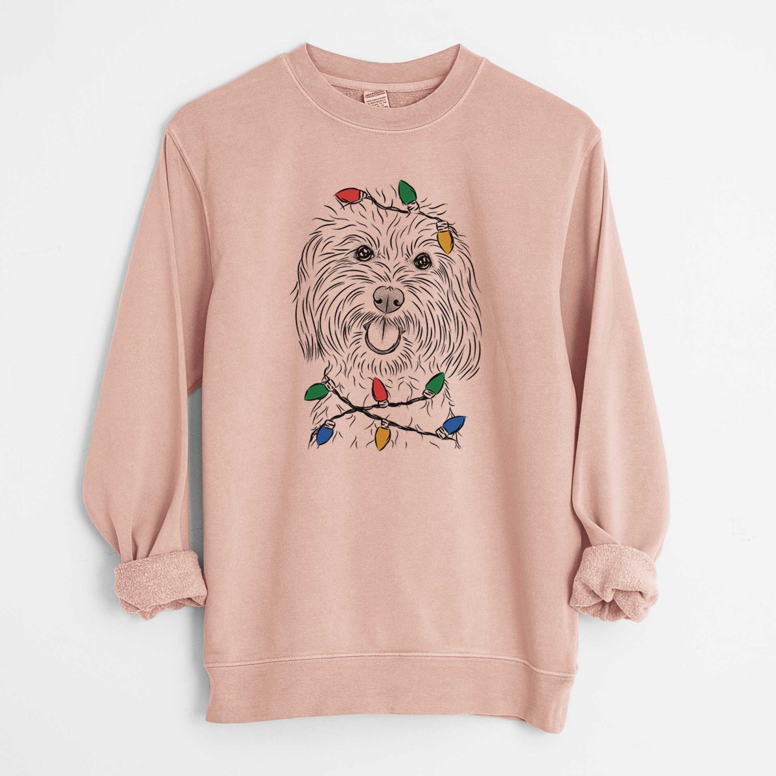 Hand-drawn sketch of Cuddles the Coton de Tulear wrapped in Christmas lights on a Dusty Pink Unisex pigment dyed crew sweatshirt