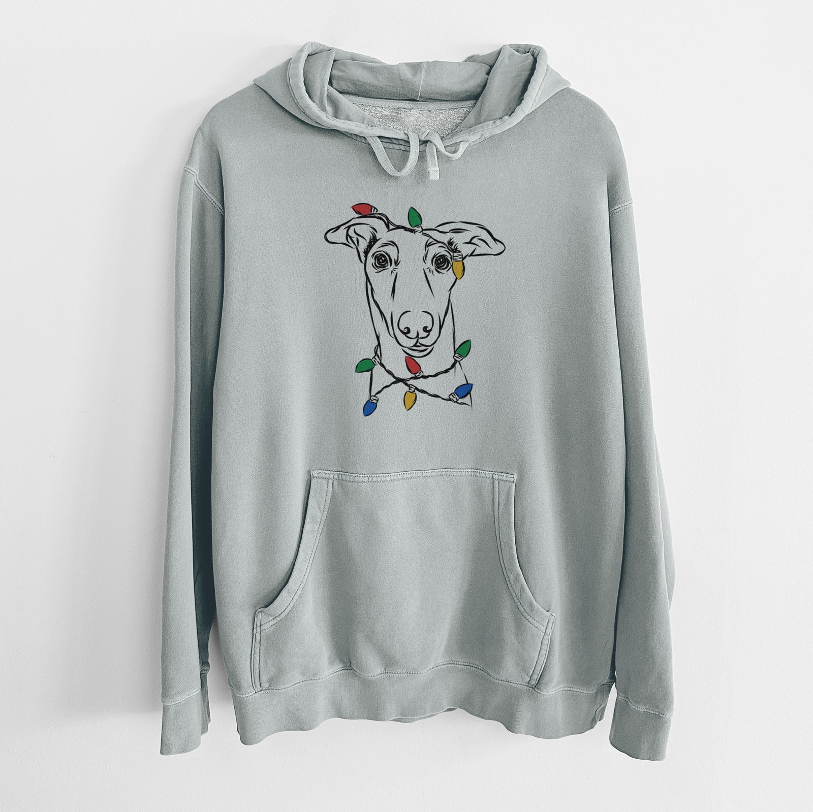 Hand-drawn sketch of Diva the Greyhound wrapped in Christmas lights on a Sage Unisex pigment dyed hoodie