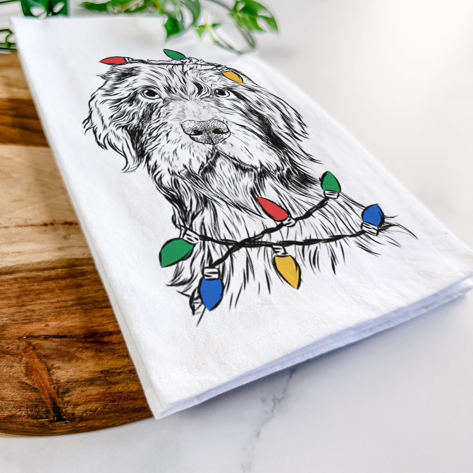 Hand-drawn sketch of Doc Holliday the Pudelpointer wrapped in Christmas lights on a tea towel