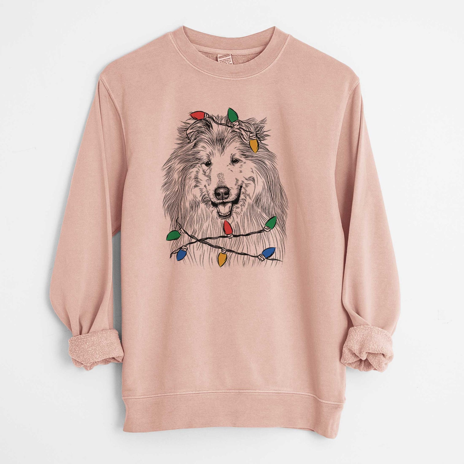 Hand-drawn sketch of Donnan the Rough Collie wrapped in Christmas lights on a Dusty Pink Unisex pigment dyed crew sweatshirt