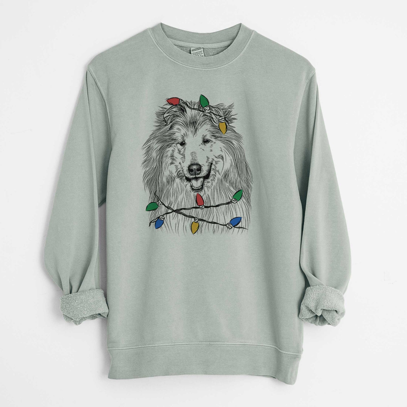 Hand-drawn sketch of Donnan the Rough Collie wrapped in Christmas lights on a Sage Unisex pigment dyed crew sweatshirt