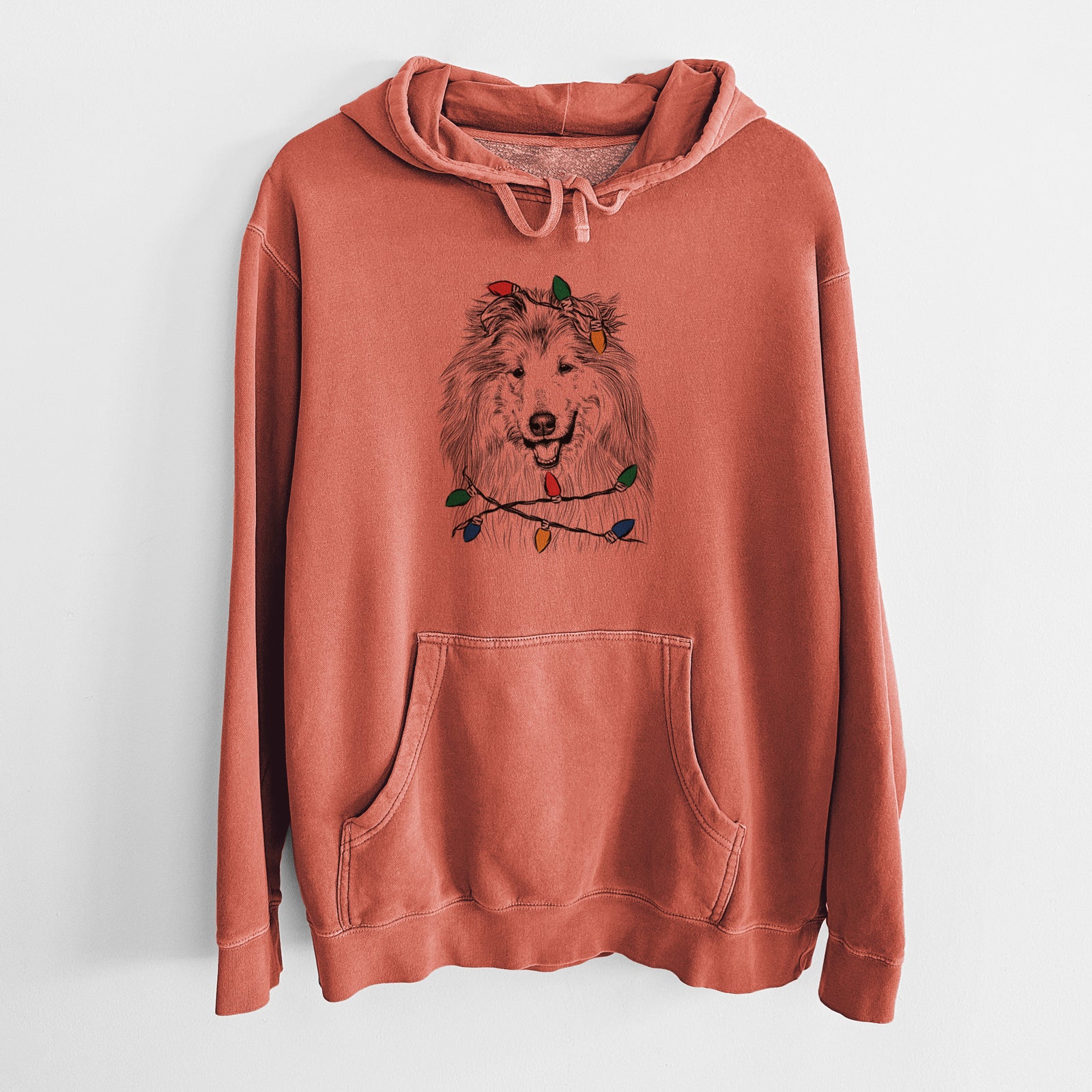 Hand-drawn sketch of Donnan the Rough Collie wrapped in Christmas lights on an Amber Unisex pigment dyed hoodie