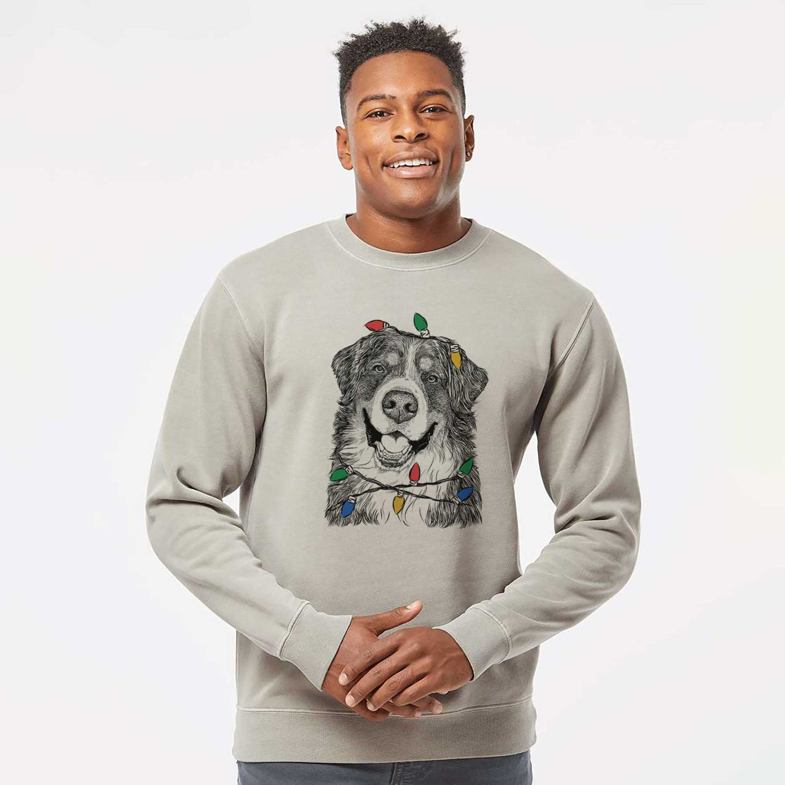 Hand-drawn sketch of Eiger the Bernese Mountain Dog wrapped in Christmas lights on a Cement Unisex pigment dyed crew sweatshirt