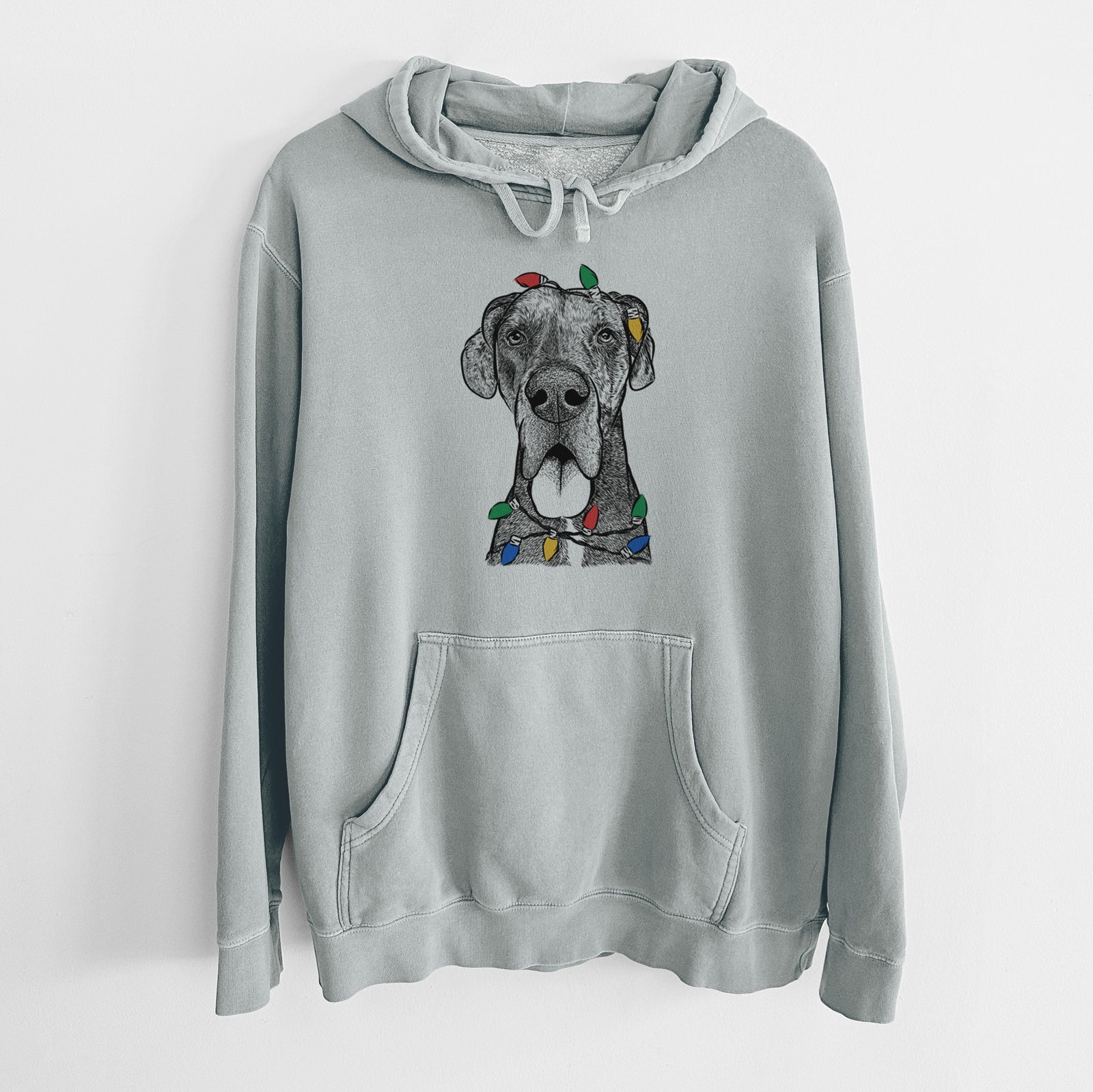 Hand-drawn sketch of Eli the Great Dane wrapped in Christmas lights on a Sage Unisex pigment dyed hoodie