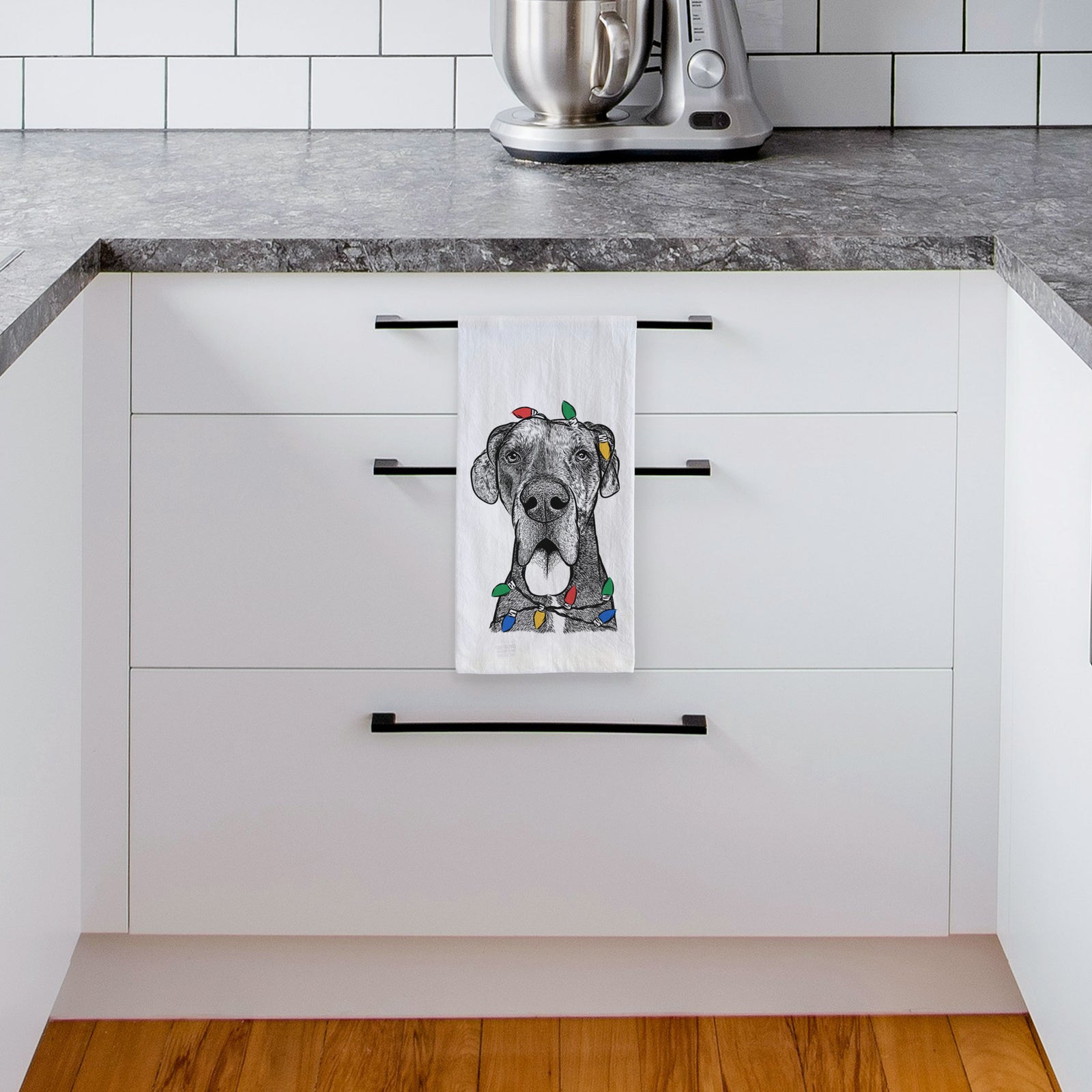 Hand-drawn sketch of Eli the Great Dane wrapped in Christmas lights on a tea towel, hanging on an oven door in a kitchen