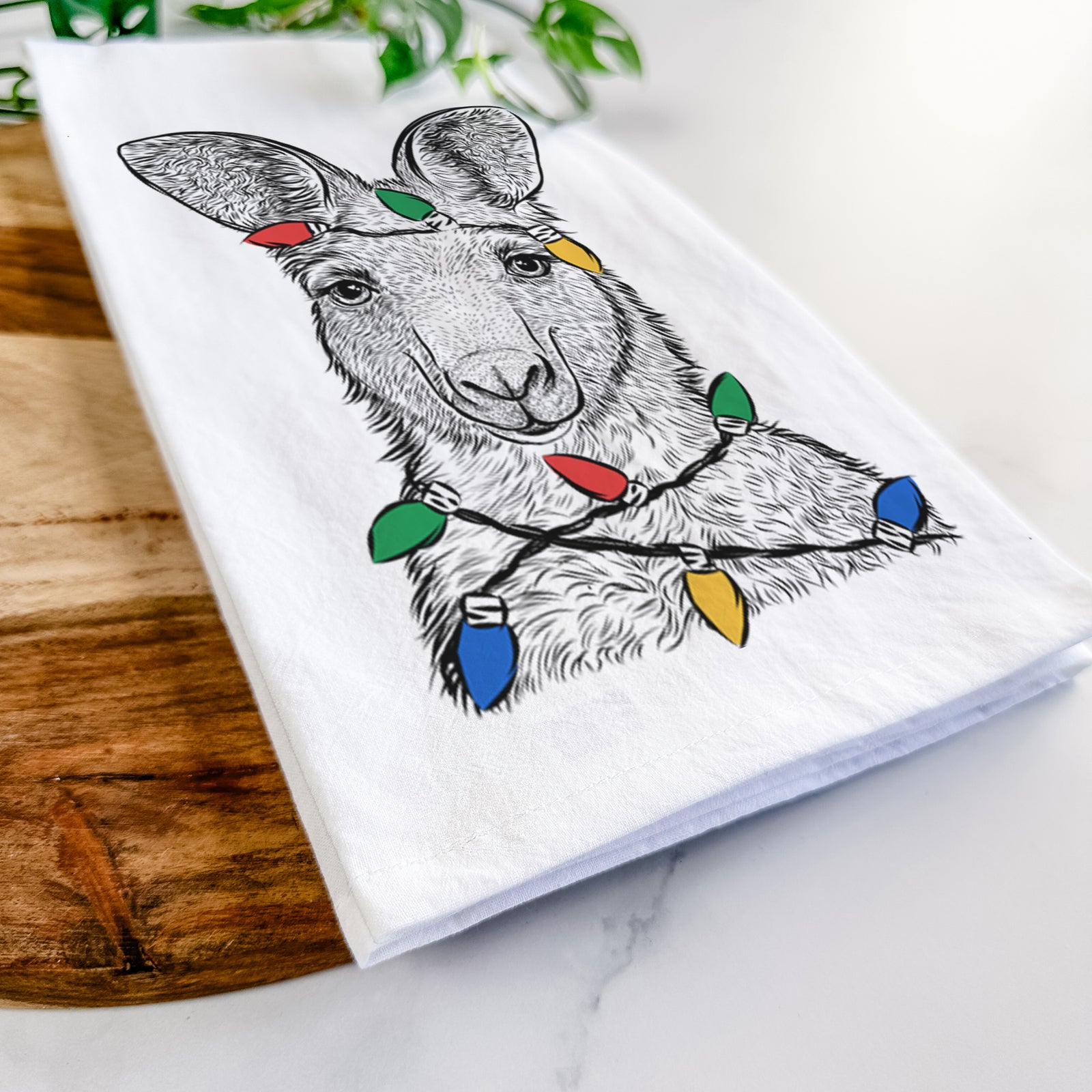 Hand-drawn sketch of Evelyn the Eastern Grey Kangaroo wrapped in Christmas lights on a tea towel
