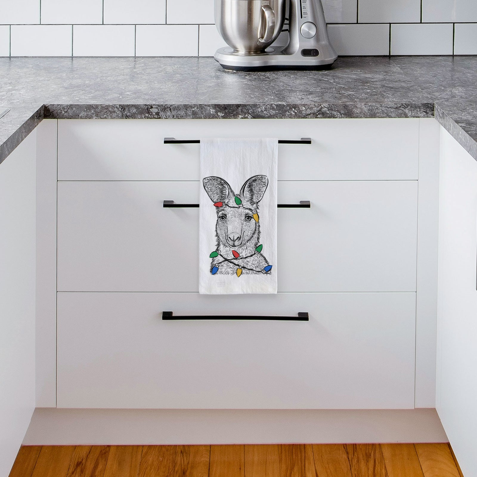 Hand-drawn sketch of Evelyn the Eastern Grey Kangaroo wrapped in Christmas lights on a tea towel, hanging on an oven door in a kitchen