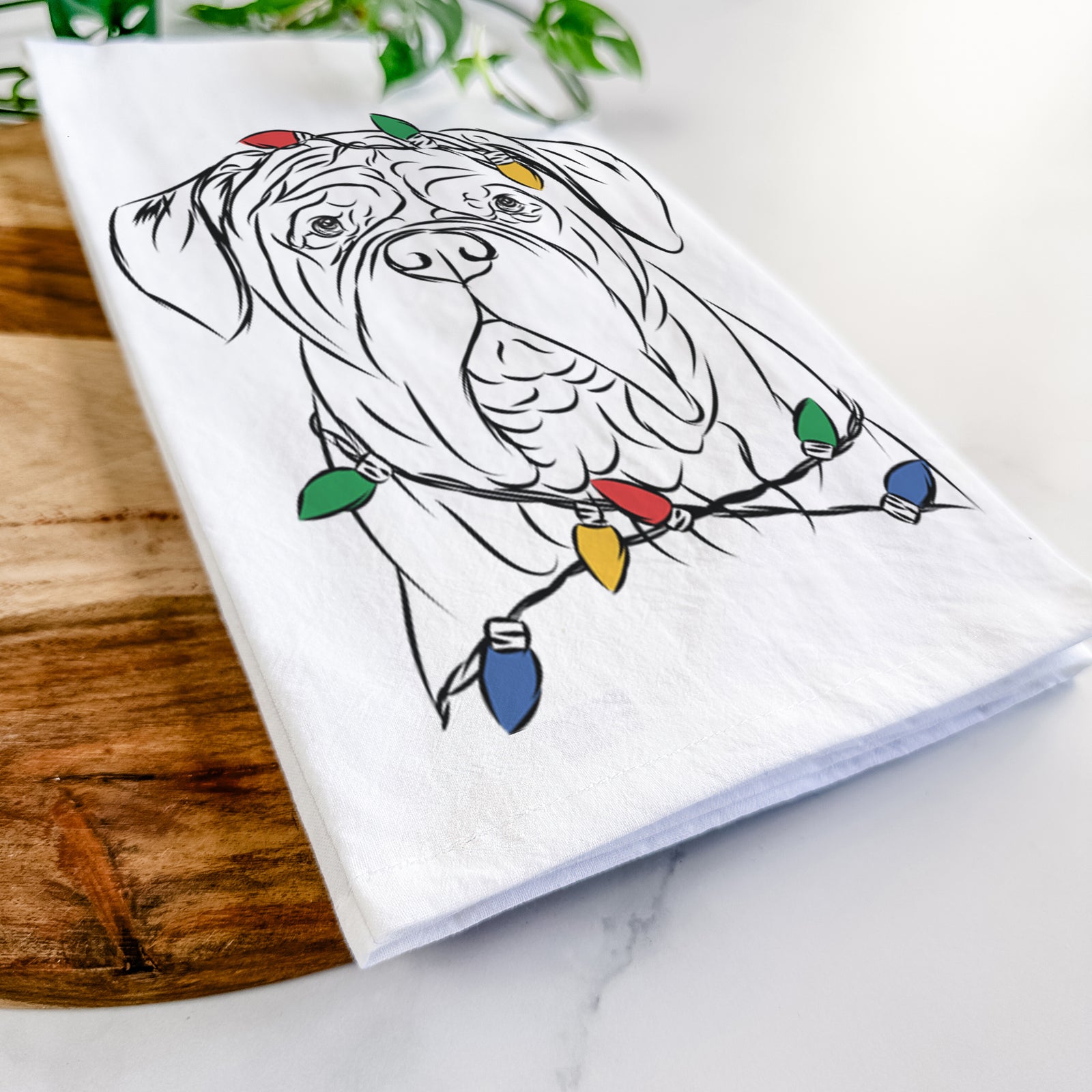 Hand-drawn sketch of Felix the Dogue de Bordeaux wrapped in Christmas lights on a tea towel