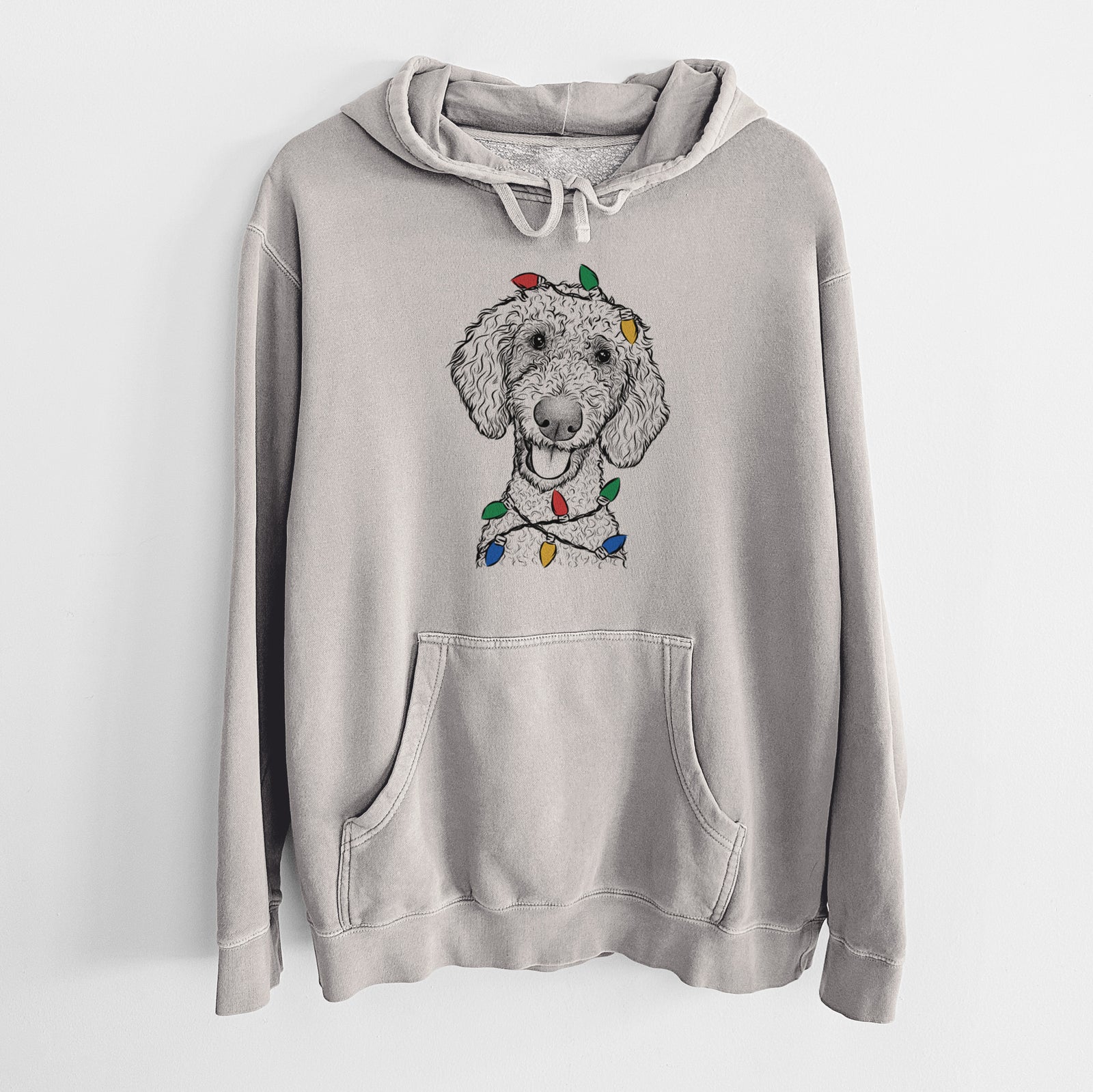 Hand-drawn sketch of Fenway the Goldendoodle wrapped in Christmas lights on a Cement Unisex pigment dyed hoodie