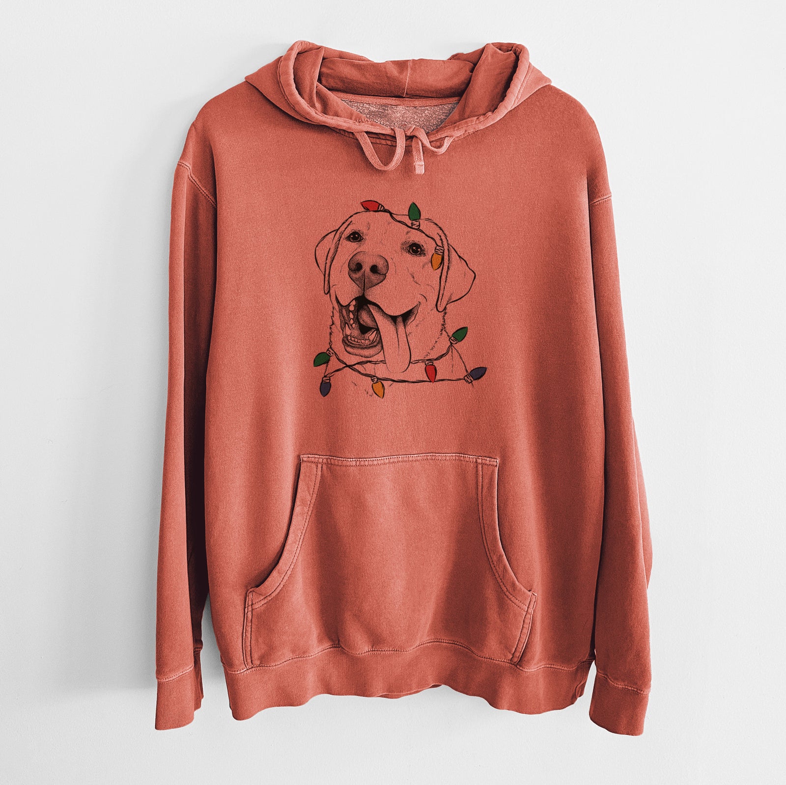 Hand-drawn sketch of Finn the Labrador Retriever wrapped in Christmas lights on an Amber Unisex pigment dyed hoodie