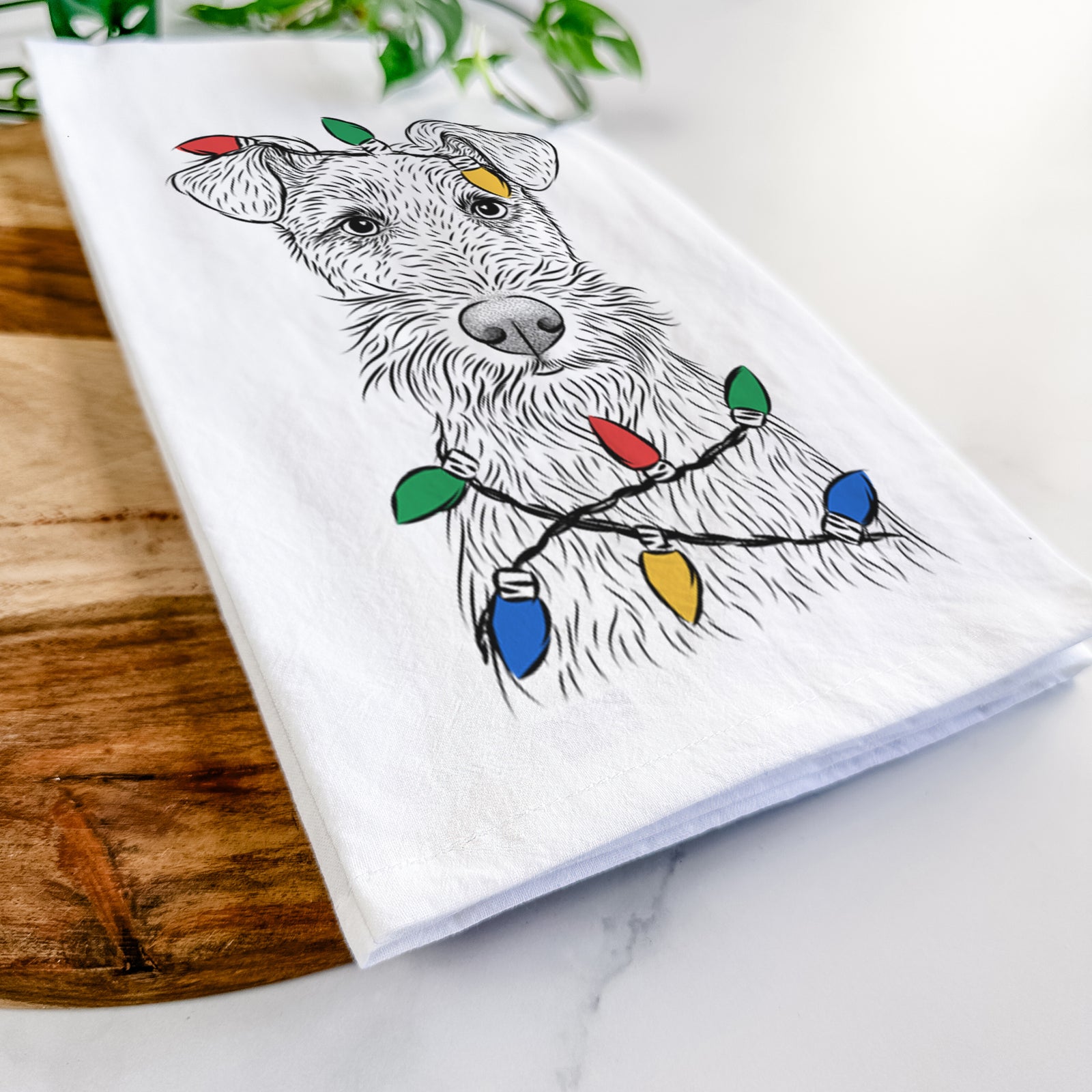 Hand-drawn sketch of Fitz the Wire Fox Terrier wrapped in Christmas lights on a tea towel