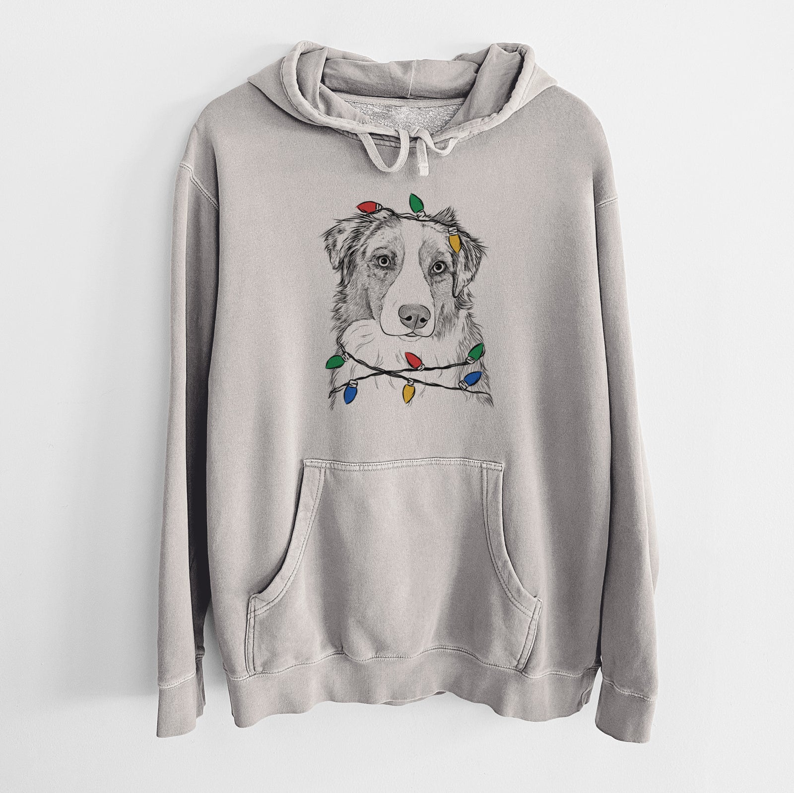Hand-drawn sketch of Ginger the Australian Shepherd wrapped in Christmas lights on a Cement Unisex pigment dyed hoodie