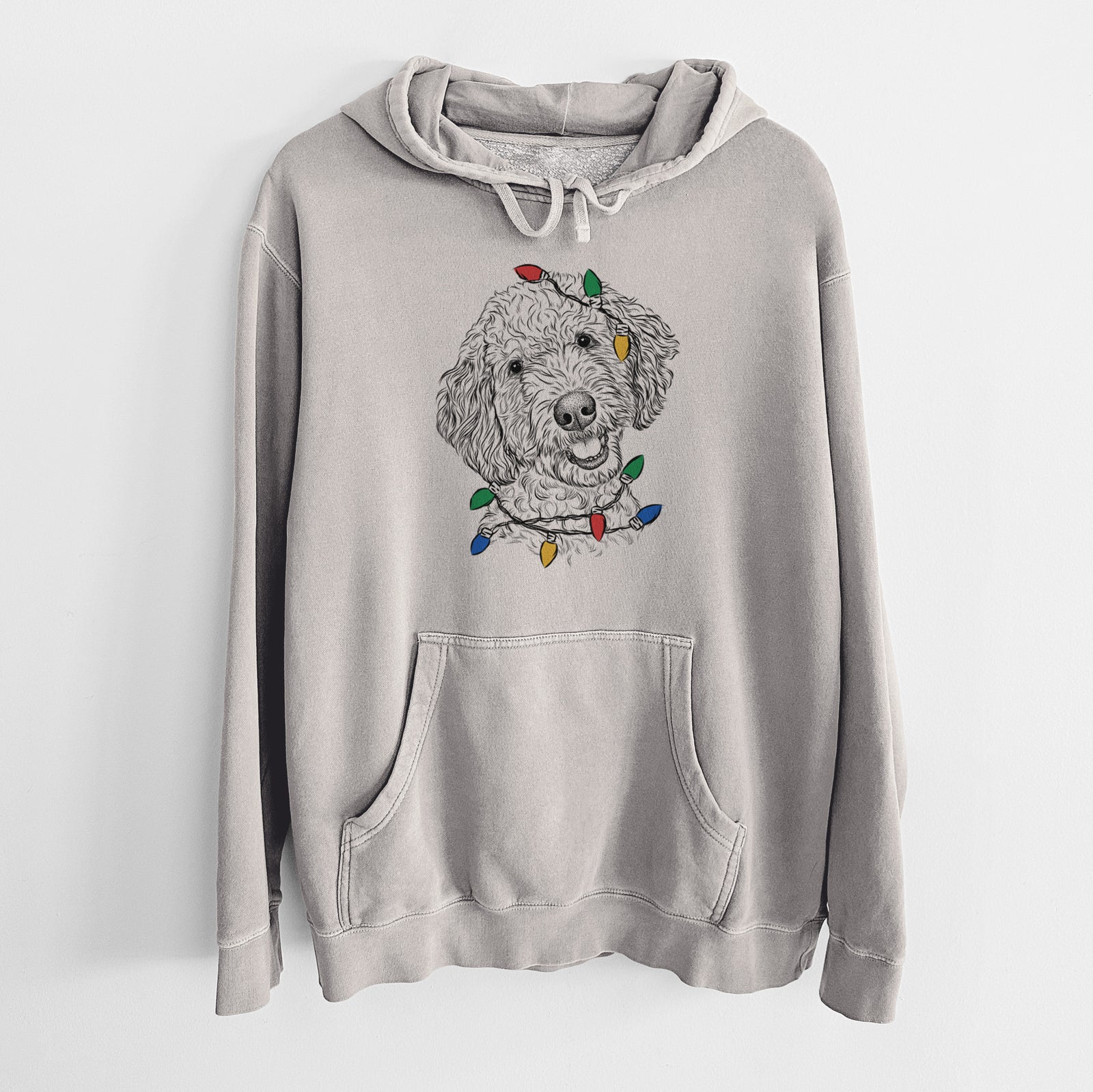 Hand-drawn sketch of Gizmo the Goldendoodle wrapped in Christmas lights on a Cement Unisex pigment dyed hoodie