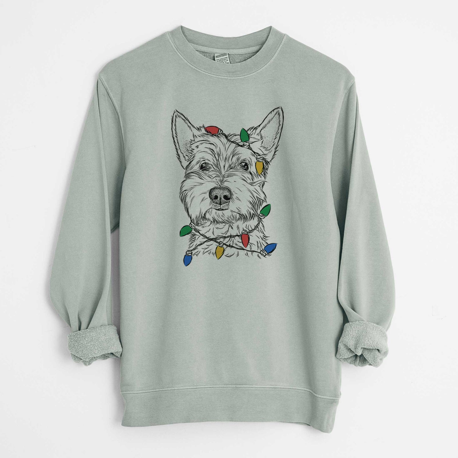 Hand-drawn sketch of Grizel the West Highland Terrier wrapped in Christmas lights on a Sage Unisex pigment dyed crew sweatshirt