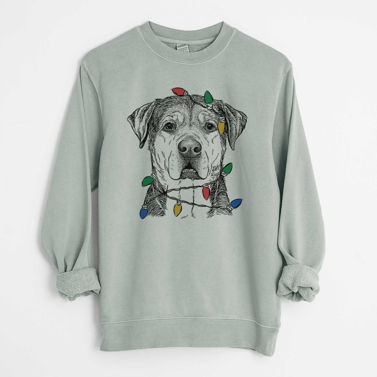Hand-drawn sketch of Gus the Rottweiler Mix wrapped in Christmas lights on a Sage Unisex pigment dyed crew sweatshirt