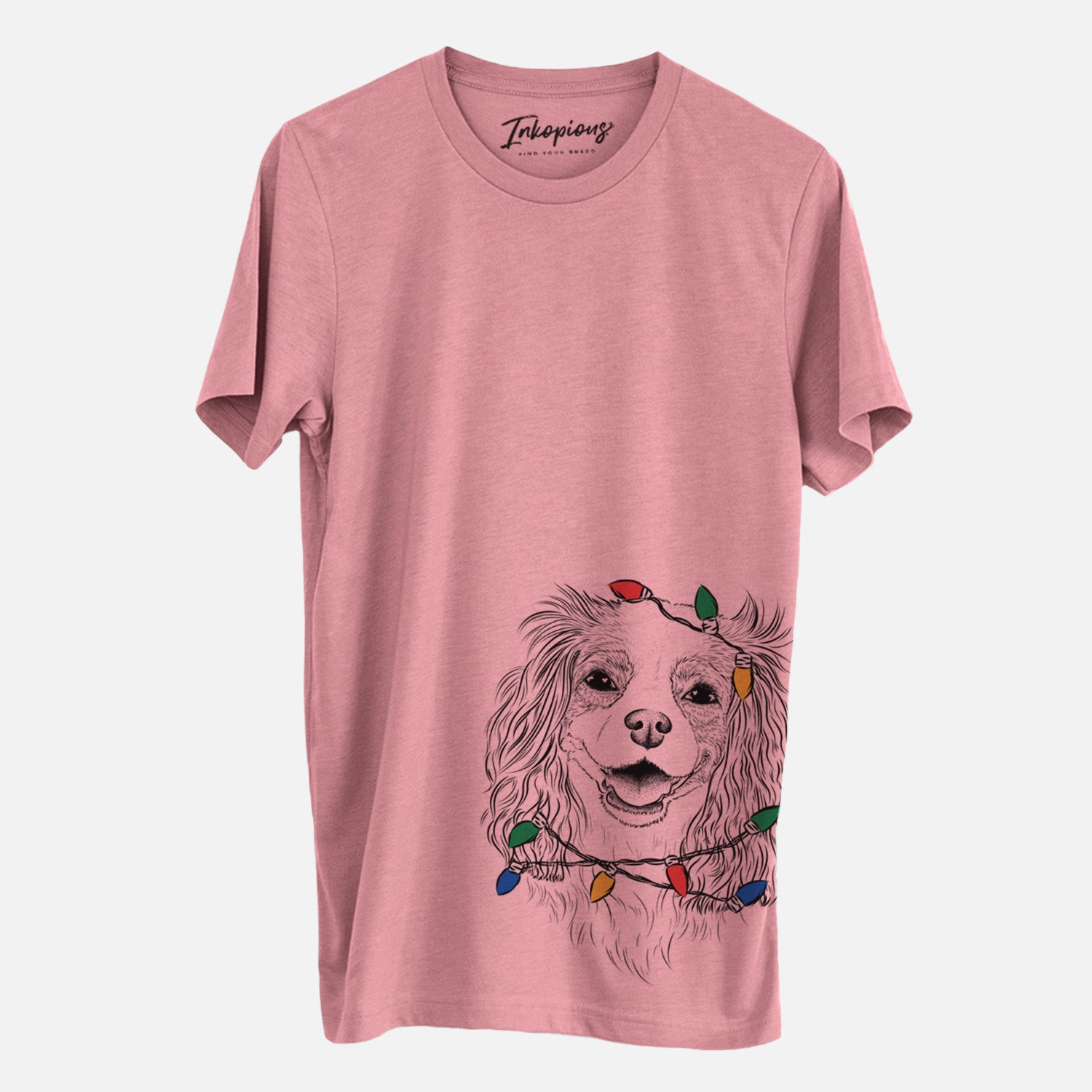 Hand-drawn sketch of Name the Cavalier King Charles Spaniel wrapped in Christmas lights on a Mauve Unisex crewneck, worn by a man