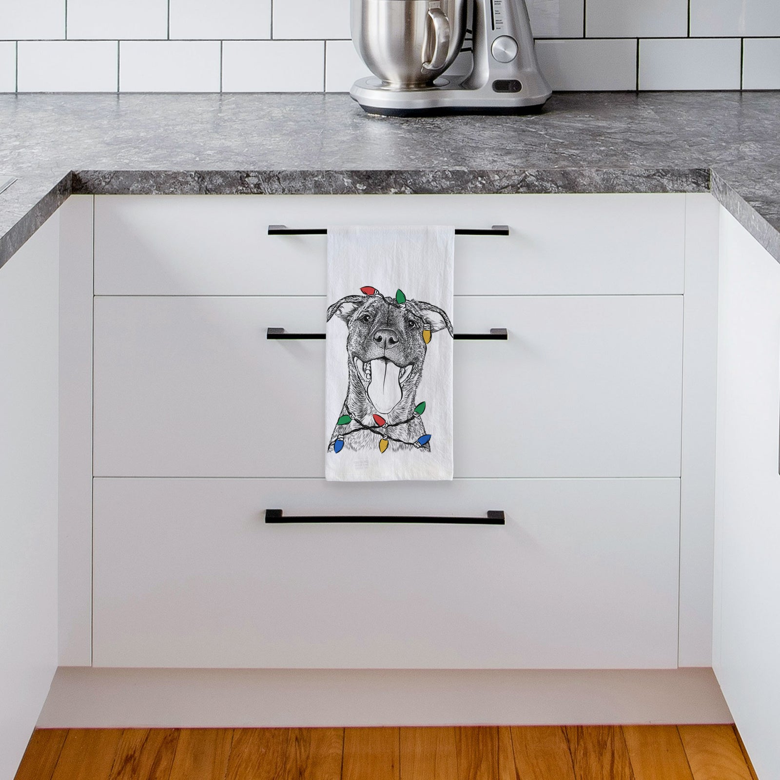 Hand-drawn sketch of Harley the Pitbull Mix wrapped in Christmas lights on a tea towel, hanging on an oven door in a kitchen